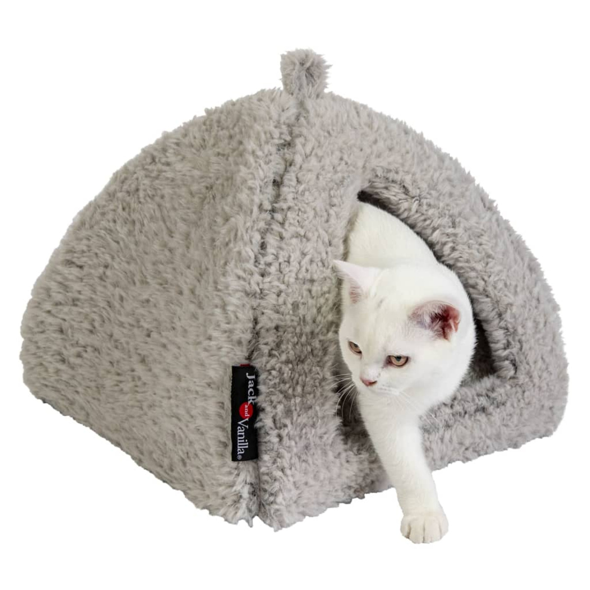 Eine weiße Katze in einem grauen Katzenbett. Die Katze schaut nach rechts.
