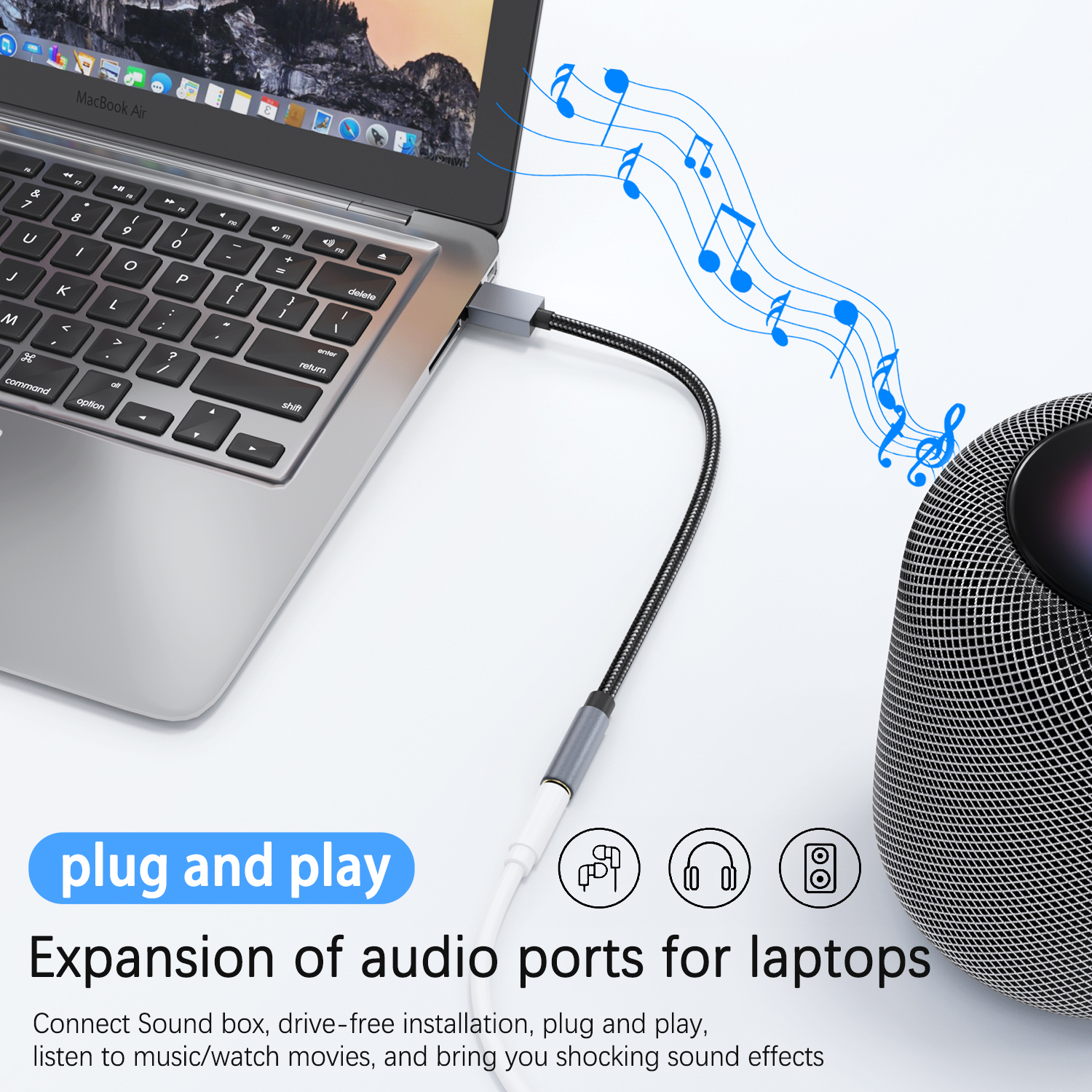 Laptop podłączony do głośnika kablem. Pokazano nuty.