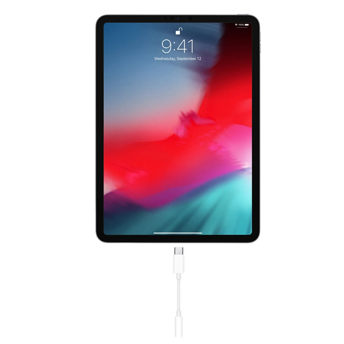 Ein iPad mit angeschlossenem Ladekabel, das einen Startbildschirm anzeigt.