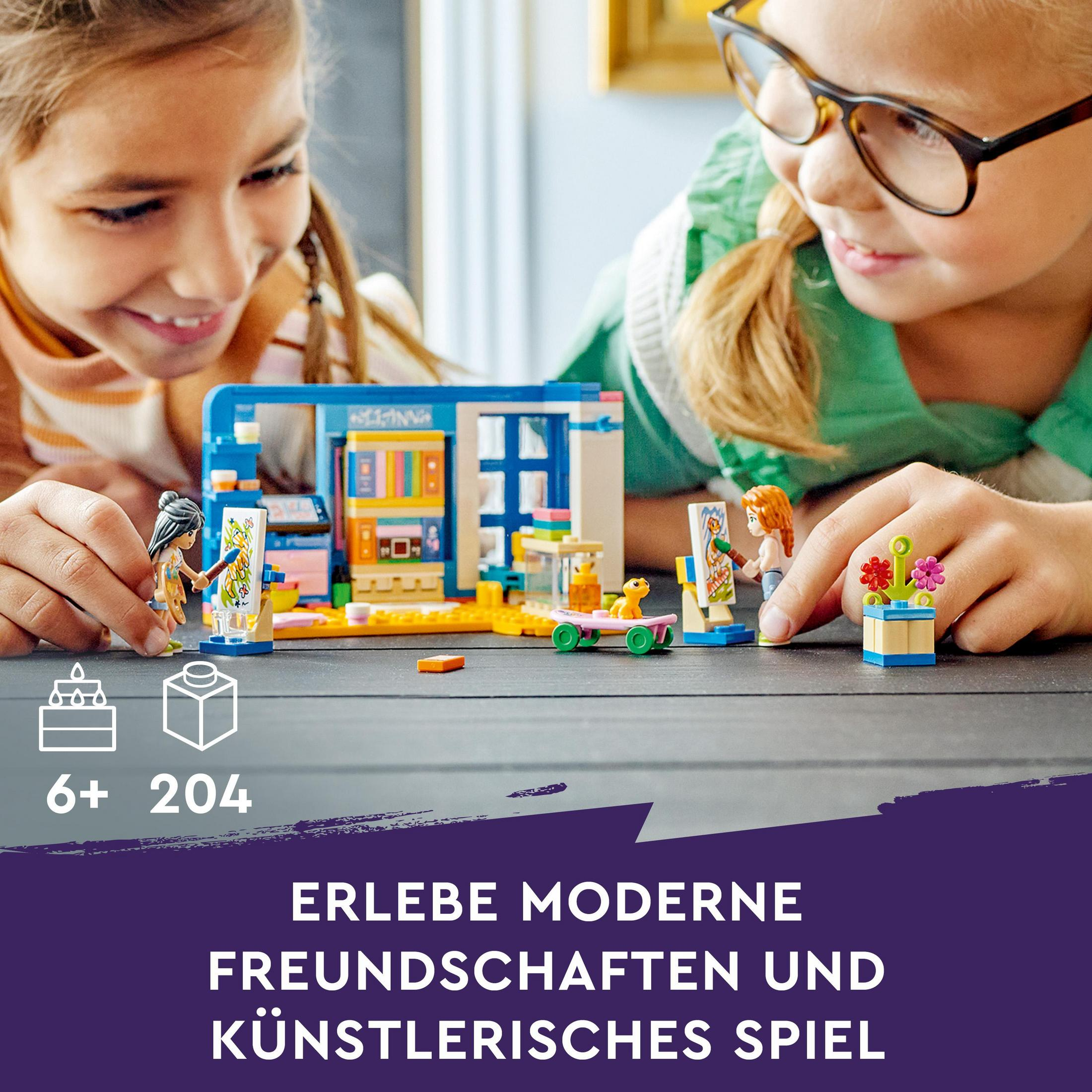 Two girls play with Lego sets on a wooden table.