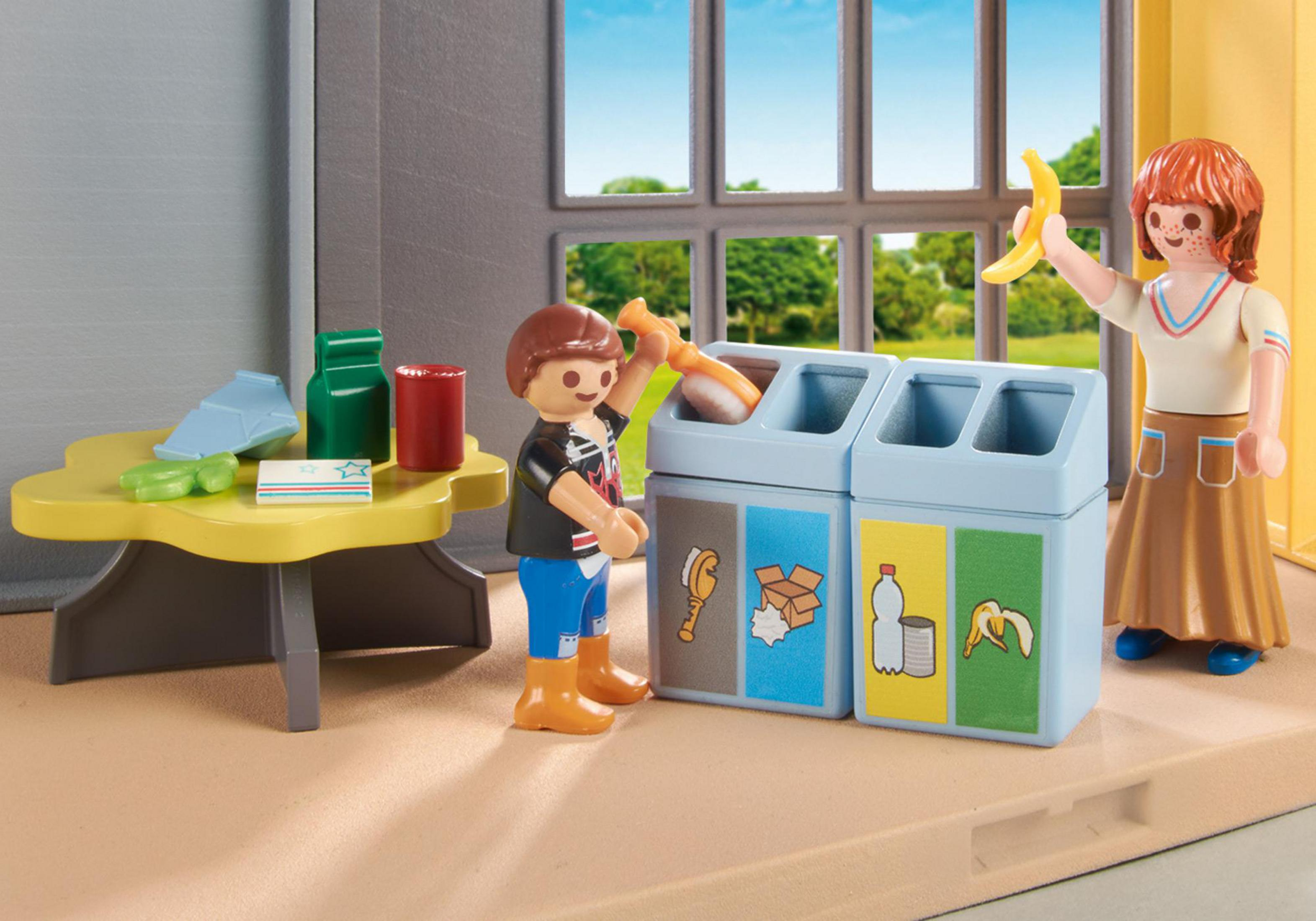 Playmobil scene: children sorting waste. One boy puts a brush in a bin, while a girl holds a banana.