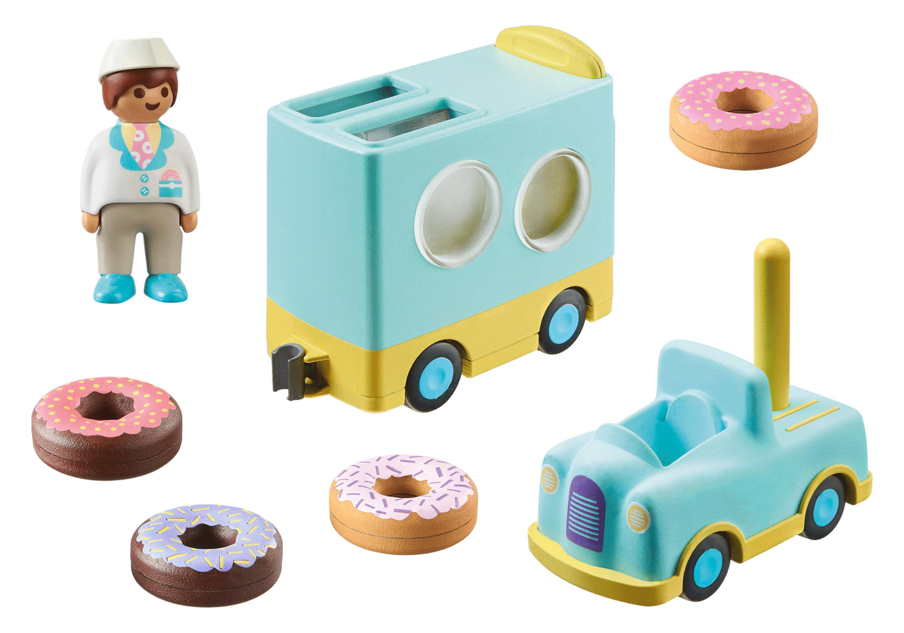 Ein Spielzeugset mit einem Bäcker und einem Foodtruck mit Donuts und einem kleinen Auto.