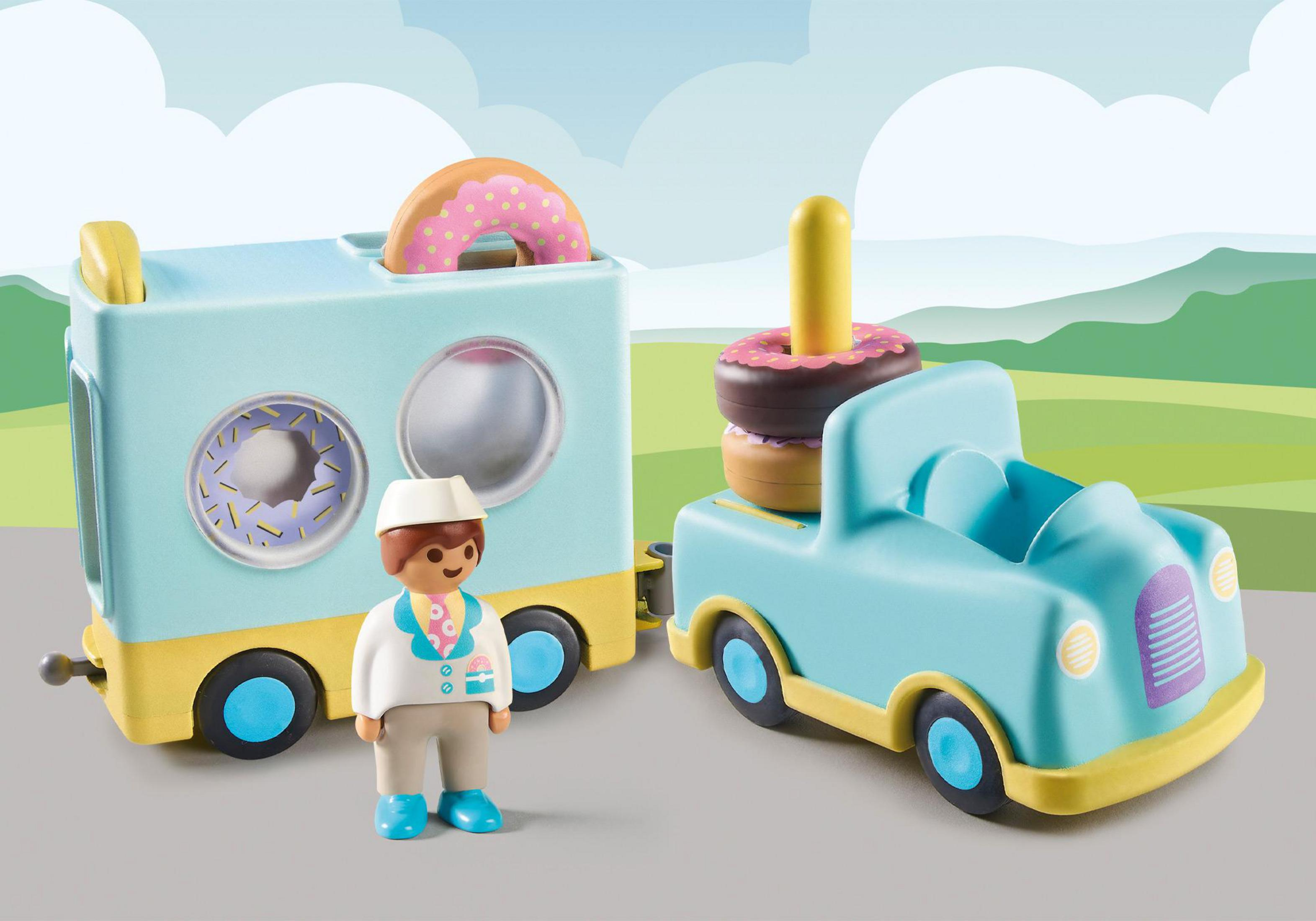 Ein Spielzeug-Donut-Truck und -Anhänger mit einer Figur. Der Truck hat hellblaue und gelbe Farben.