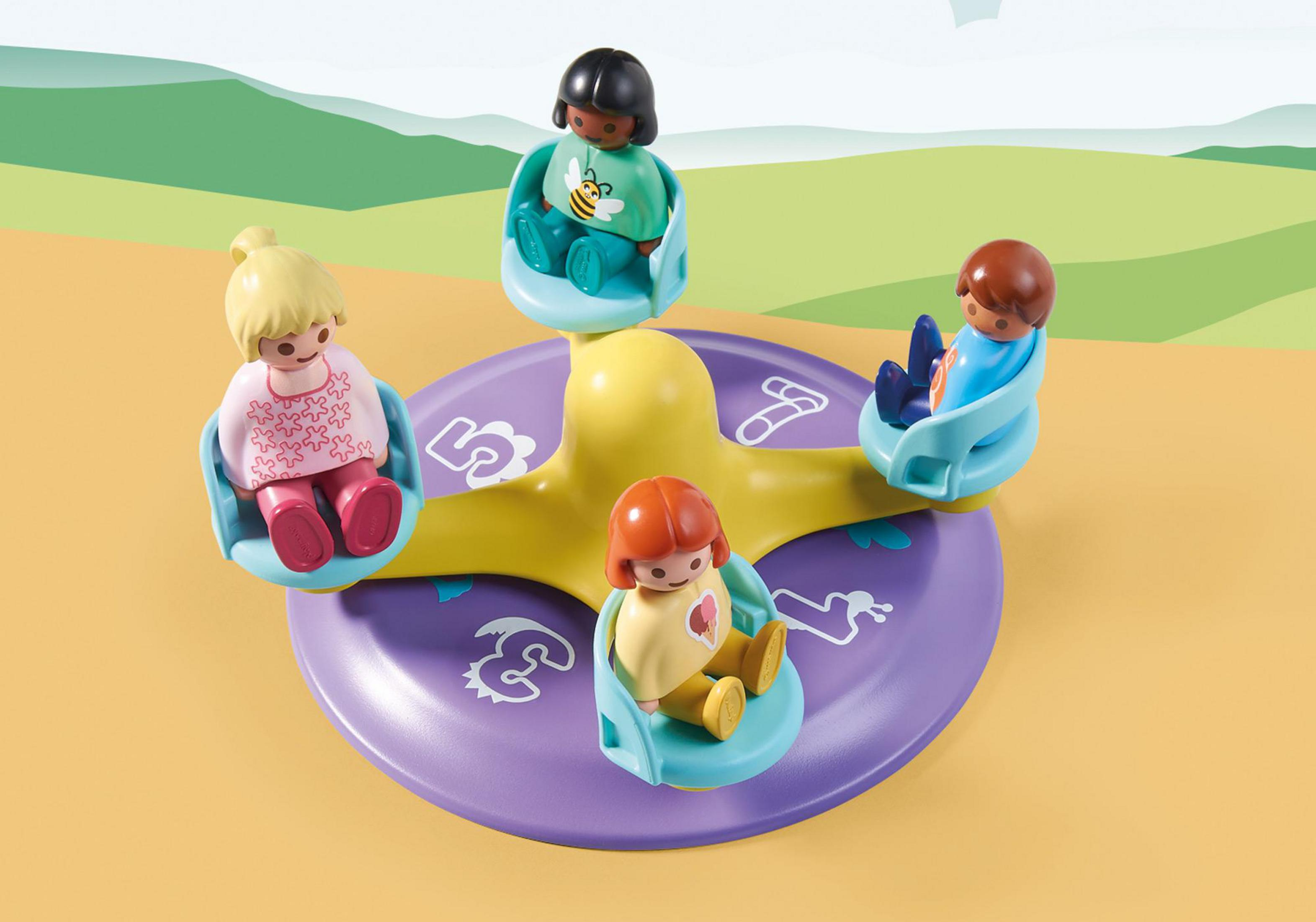 Un giocattolo a giostra con quattro figure di bambini seduti sui sedili. La giostra è gialla e viola.