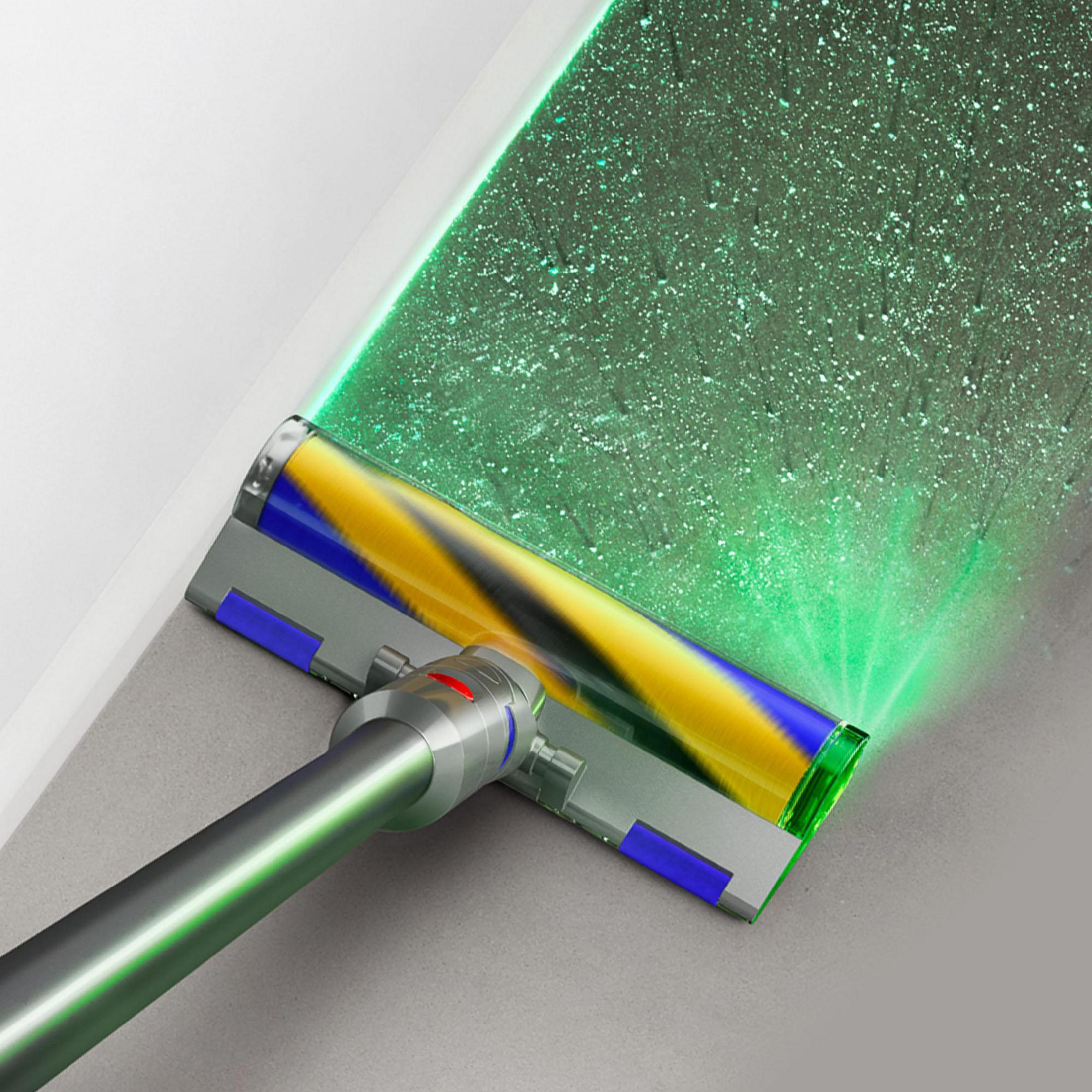 Testa dell'aspirapolvere Dyson che emette un raggio laser verde, pulendo un pavimento con particelle di polvere.