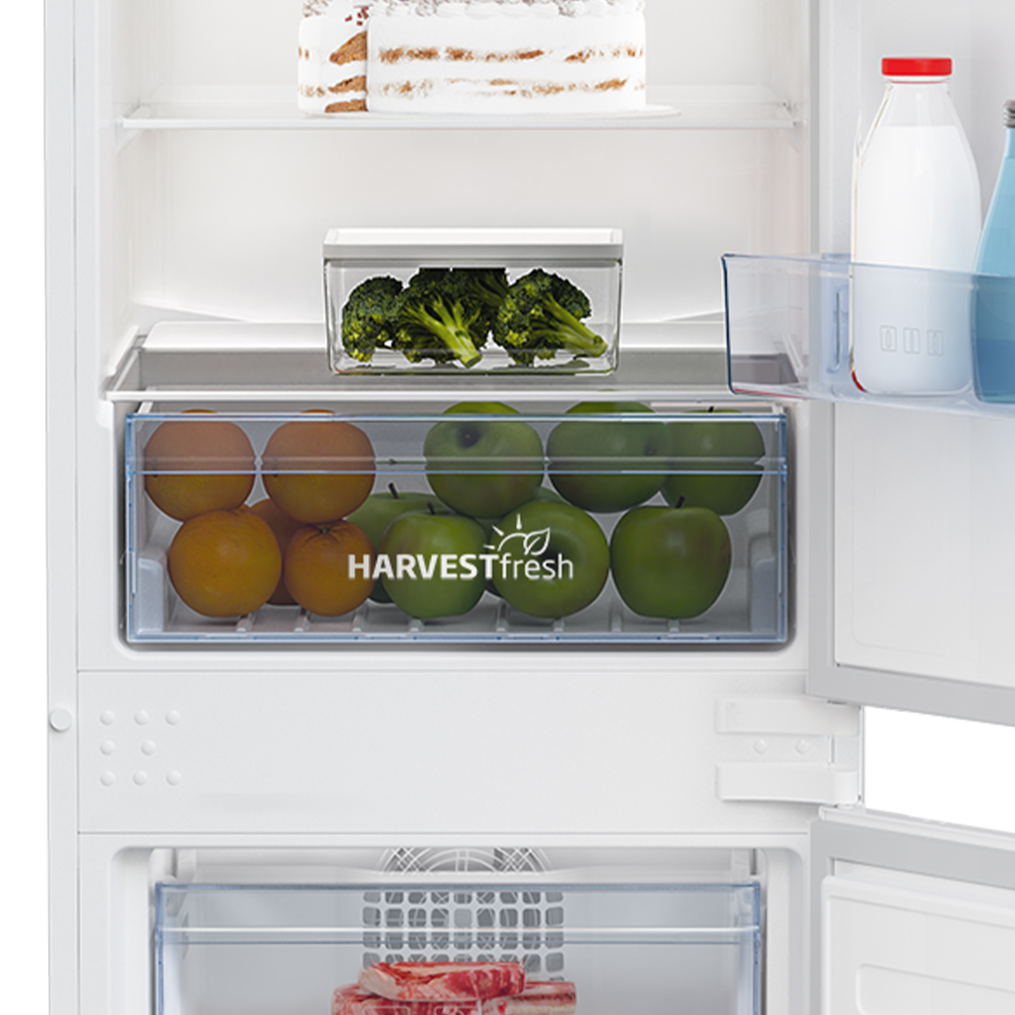 Inside a refrigerator with fruits, vegetables, and food.