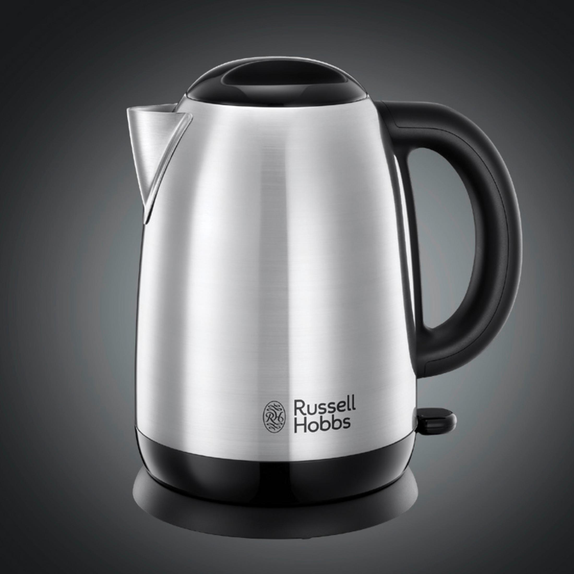 A silver and black Russell Hobbs electric kettle on a black surface.