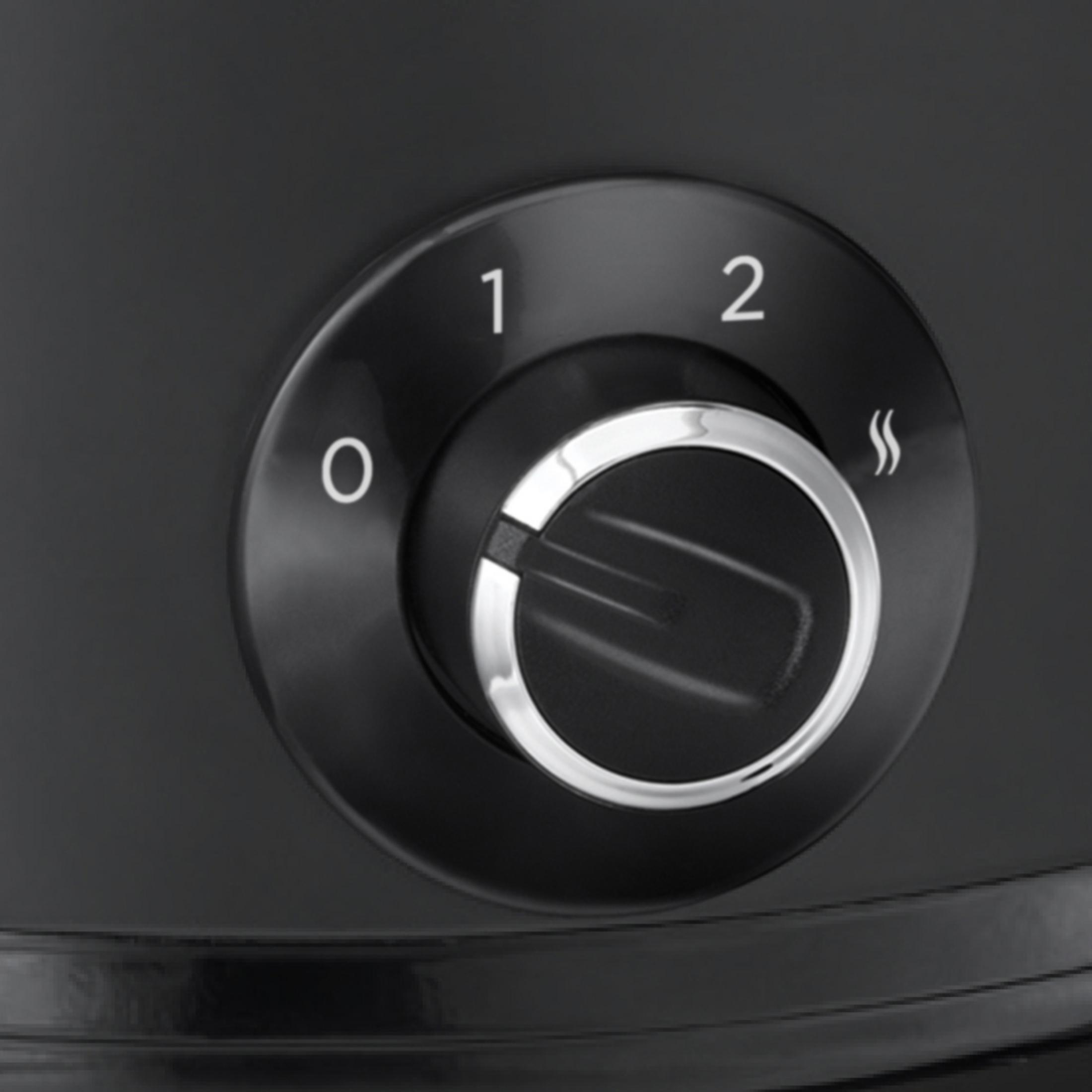 Un dial de control negro con los números 0, 1, 2. Hay un anillo plateado alrededor del dial.