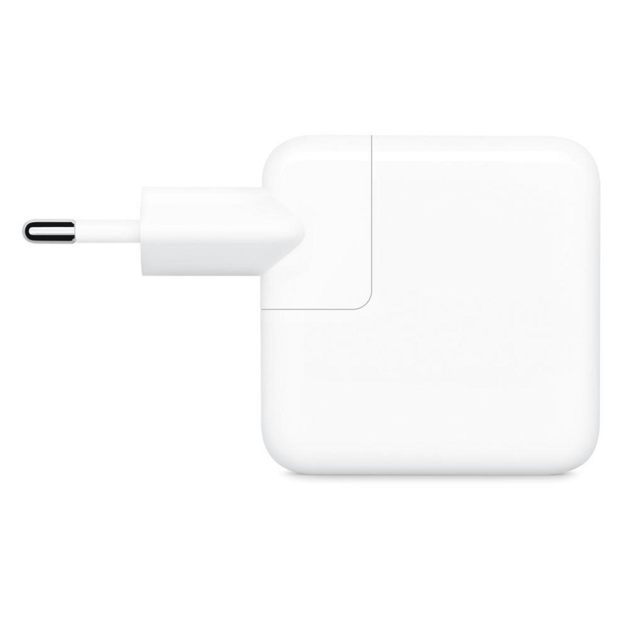 A white Apple charger with a plug for an outlet.