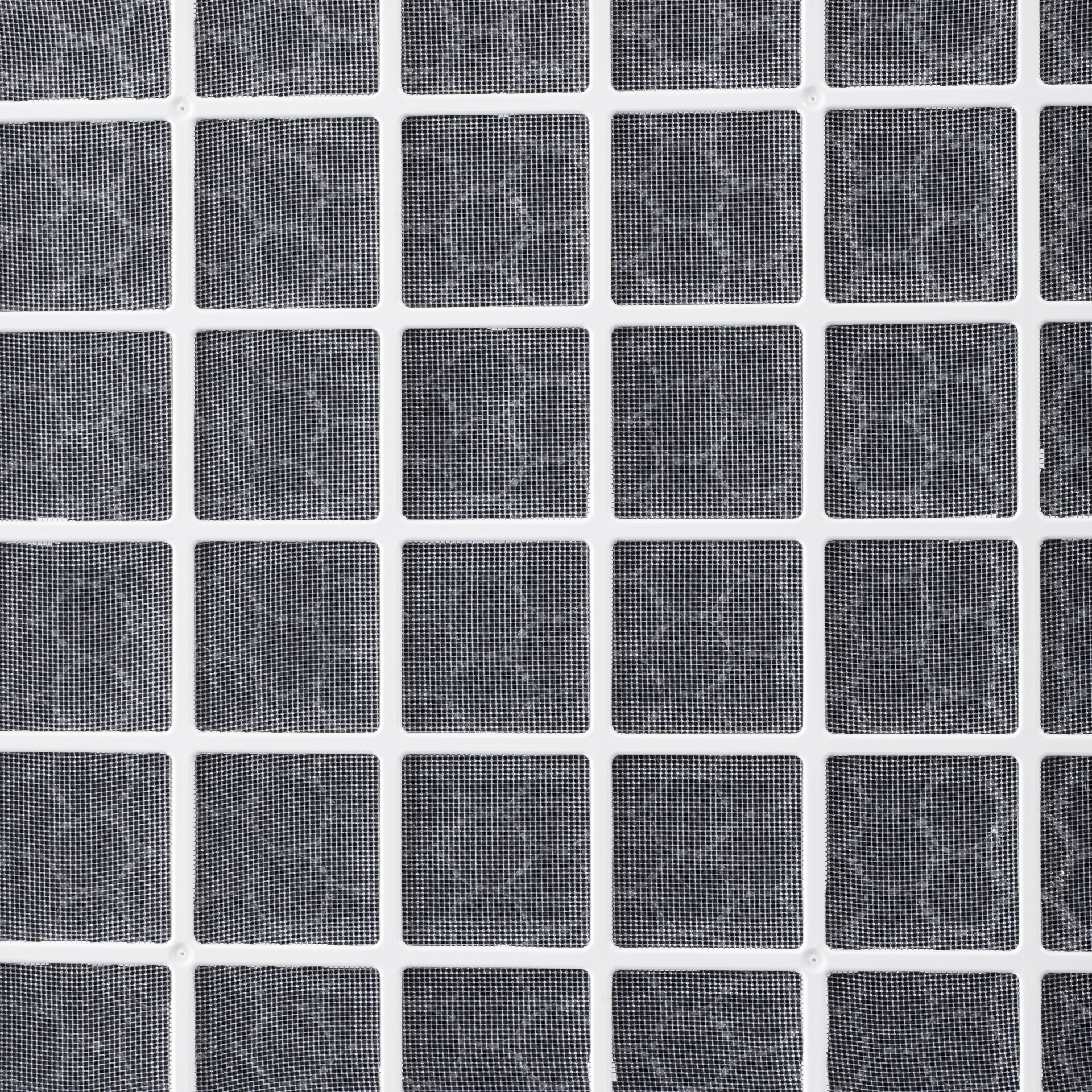 A close-up shot of a white-framed screen with a grid of small, dark gray squares.