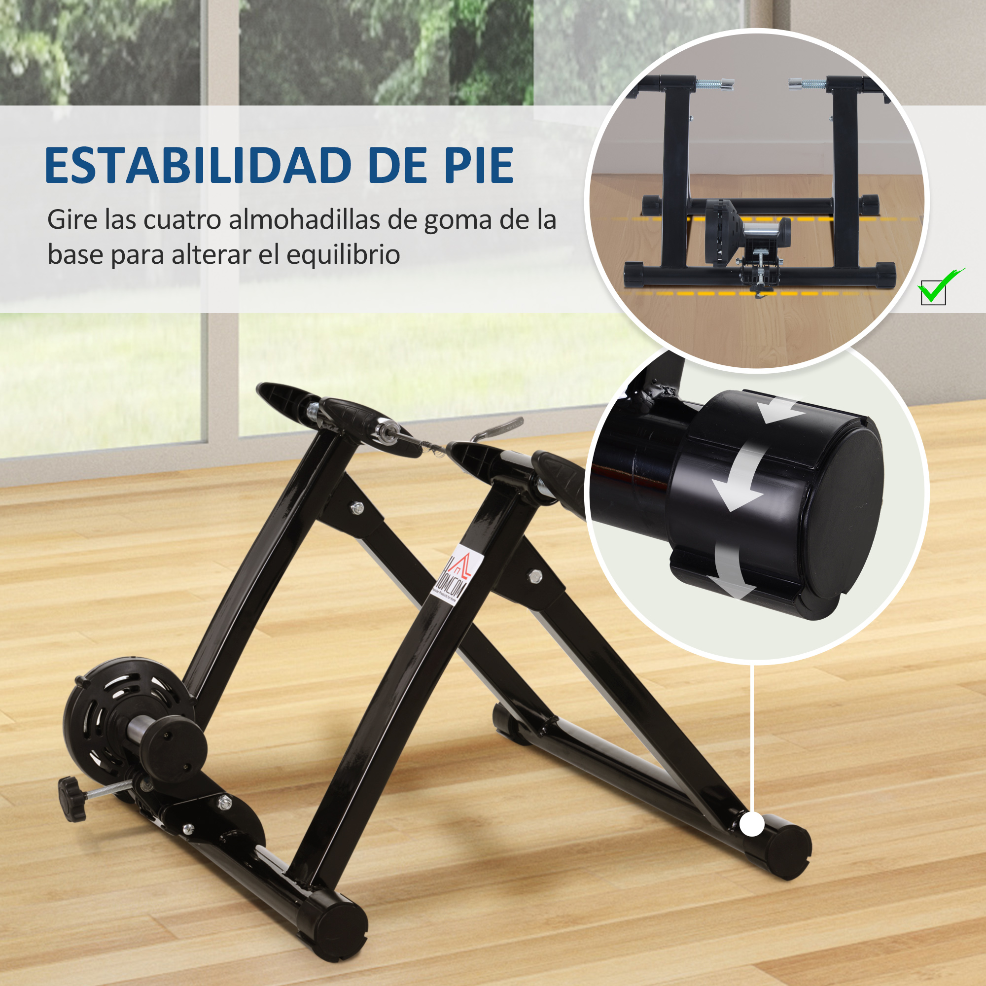 Un entrenador de bicicleta negro sobre un piso de madera con un diagrama arriba a la derecha.