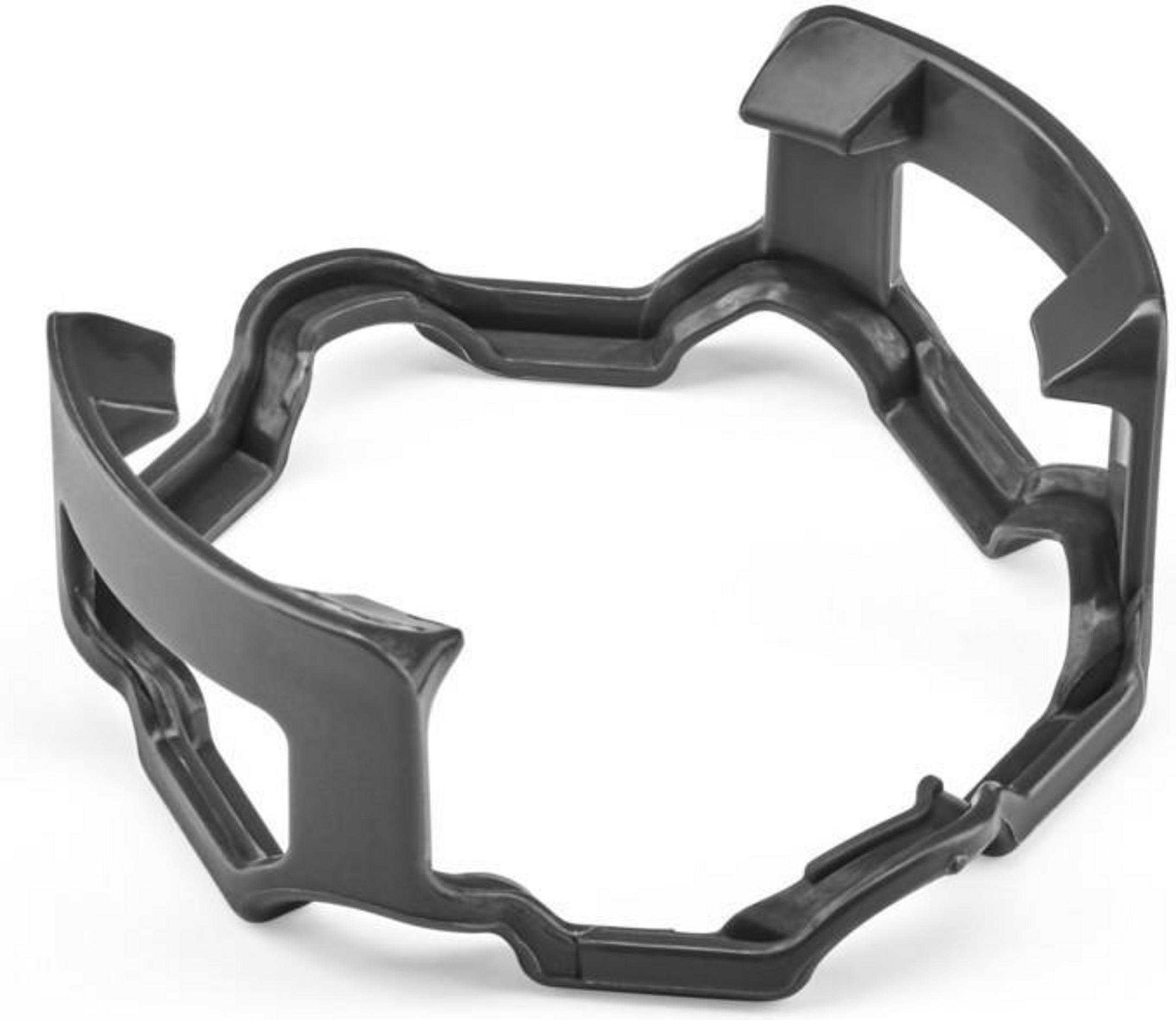 A dark gray plastic ring, likely a component, with an irregular shape and several cutouts.
