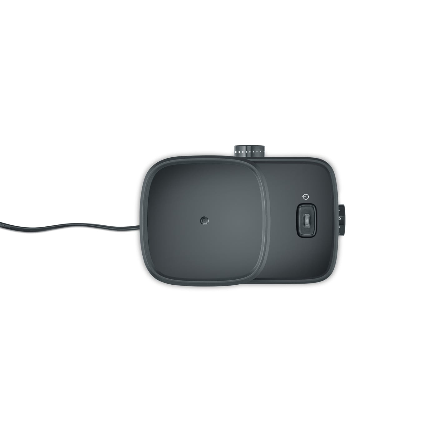 Ciemnoszare urządzenie, prawdopodobnie głośnik lub ładowarka, z przyciskiem zasilania.