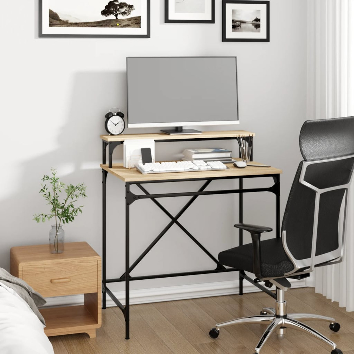 Büro-Schreibtisch-Setup mit Monitor, Tastatur und Stuhl. Es gibt eine Pflanze.