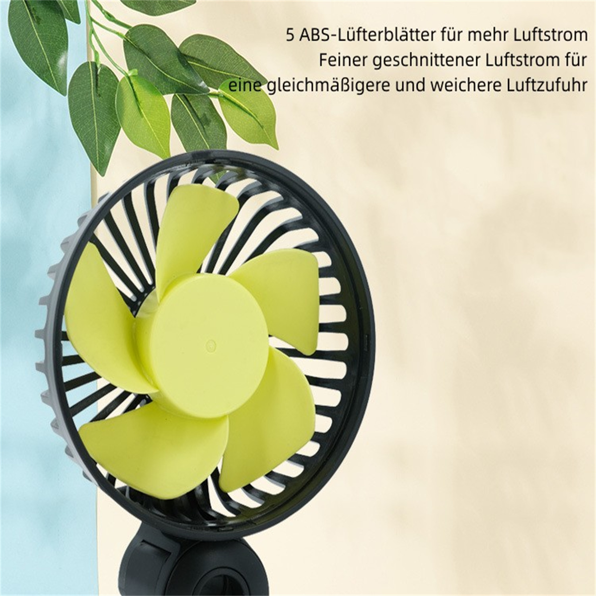 Un mini ventilador negro y verde con aspas verdes, texto en alemán y una hoja.