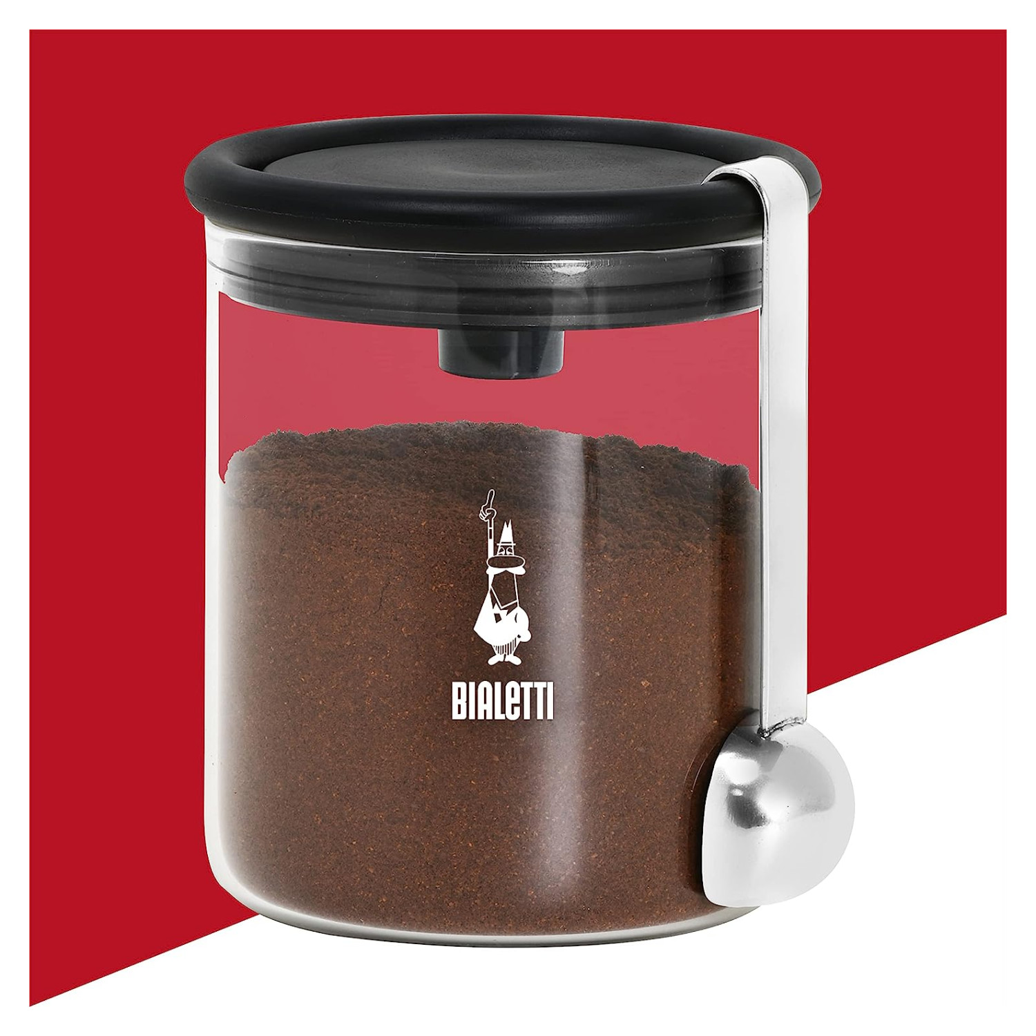 Un contenitore per caffè Bialetti in vetro con coperchio nero e cucchiaio.