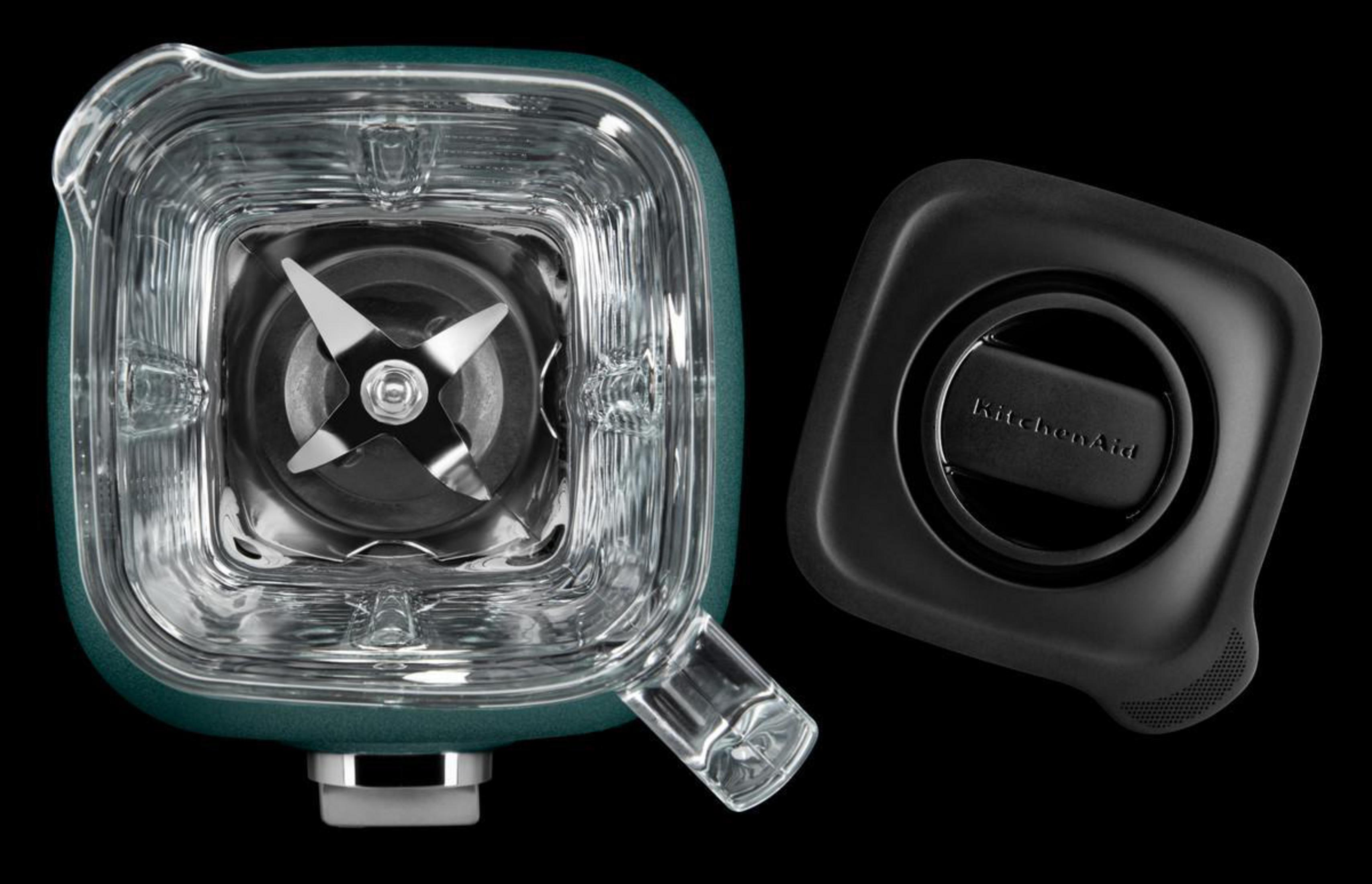 Blenderteile: Grüner Sockel, transparenter Behälter und schwarzer Deckel.