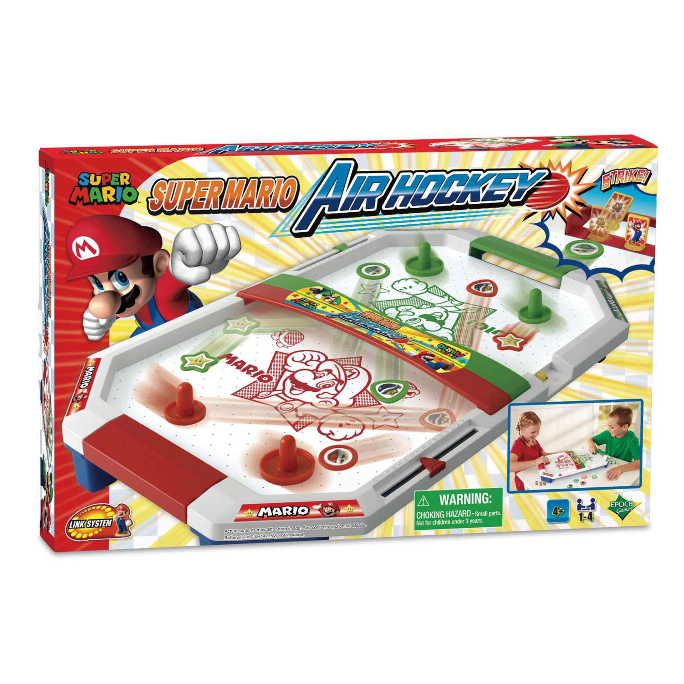 Super Mario air hockey game box. Mario looks on. Game board visible. Two kids play.