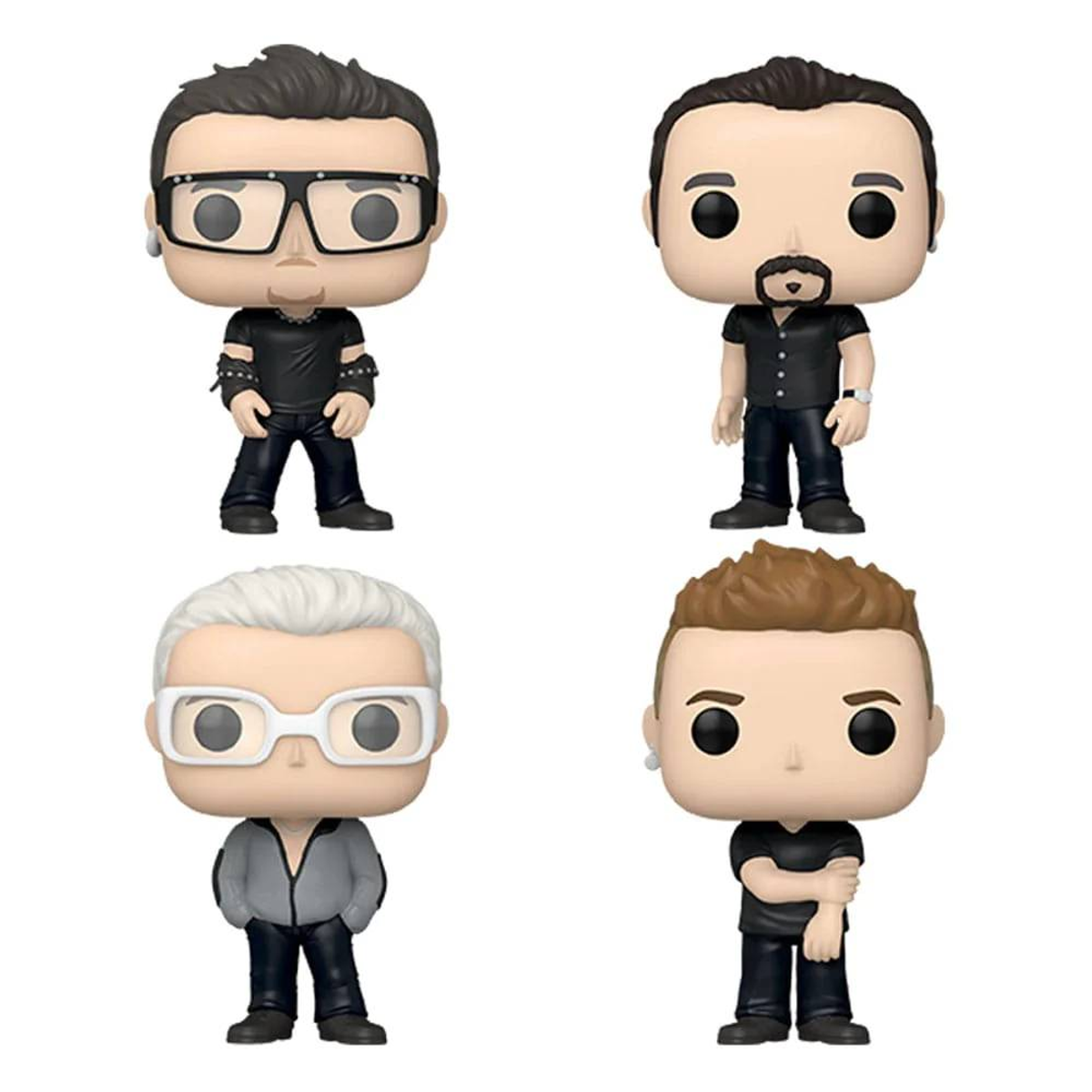 Cuatro figuras Funko Pop de miembros de la banda Depeche Mode. Cada figura está estilizada con ropa negra.