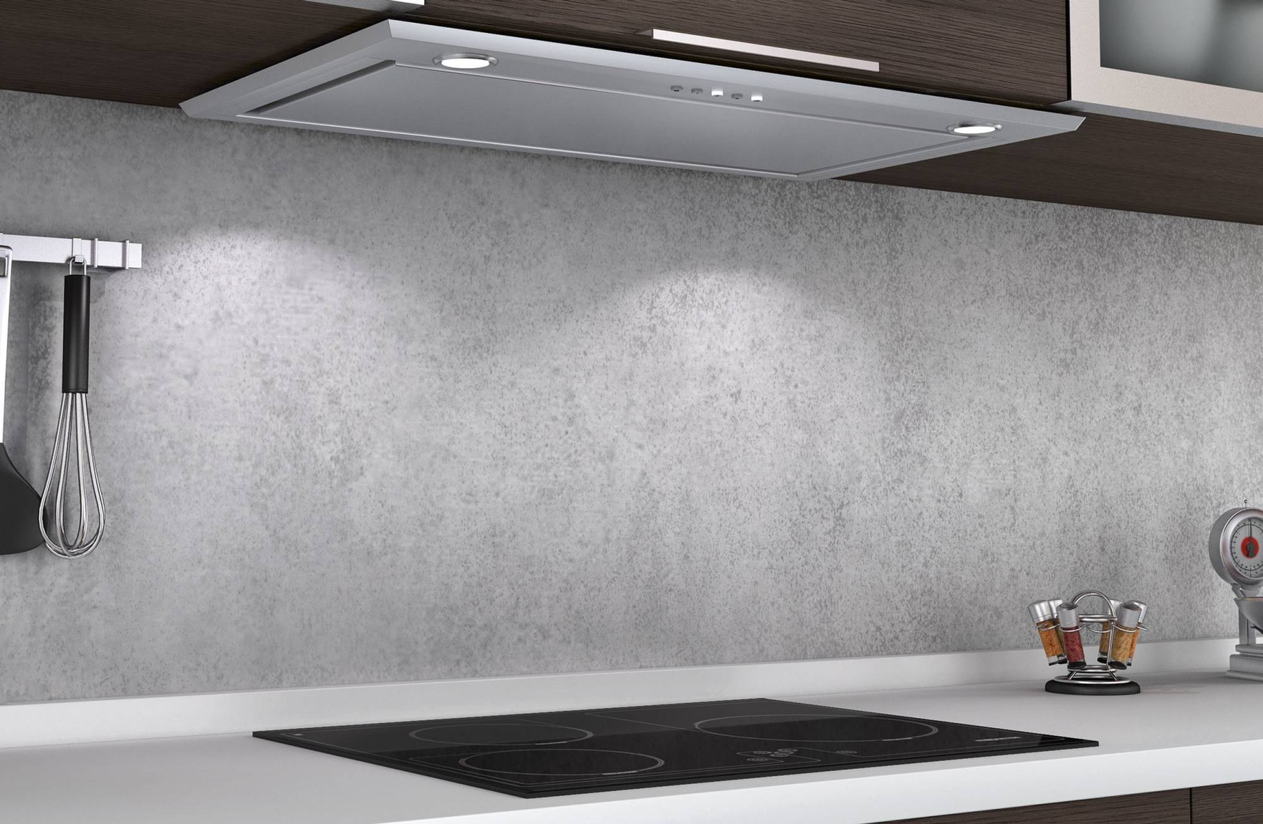Una escena de cocina con campana extractora, vitrocerámica y pared gris clara.