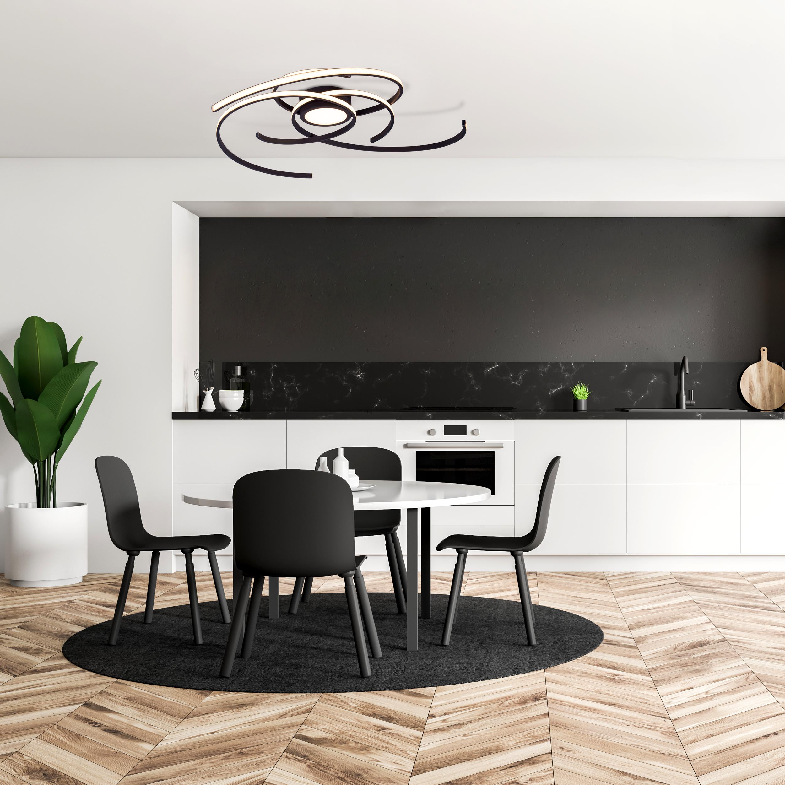 Eine moderne Küche mit schwarzen Schränken, einem schwarzen runden Teppich und einem weißen Tisch.