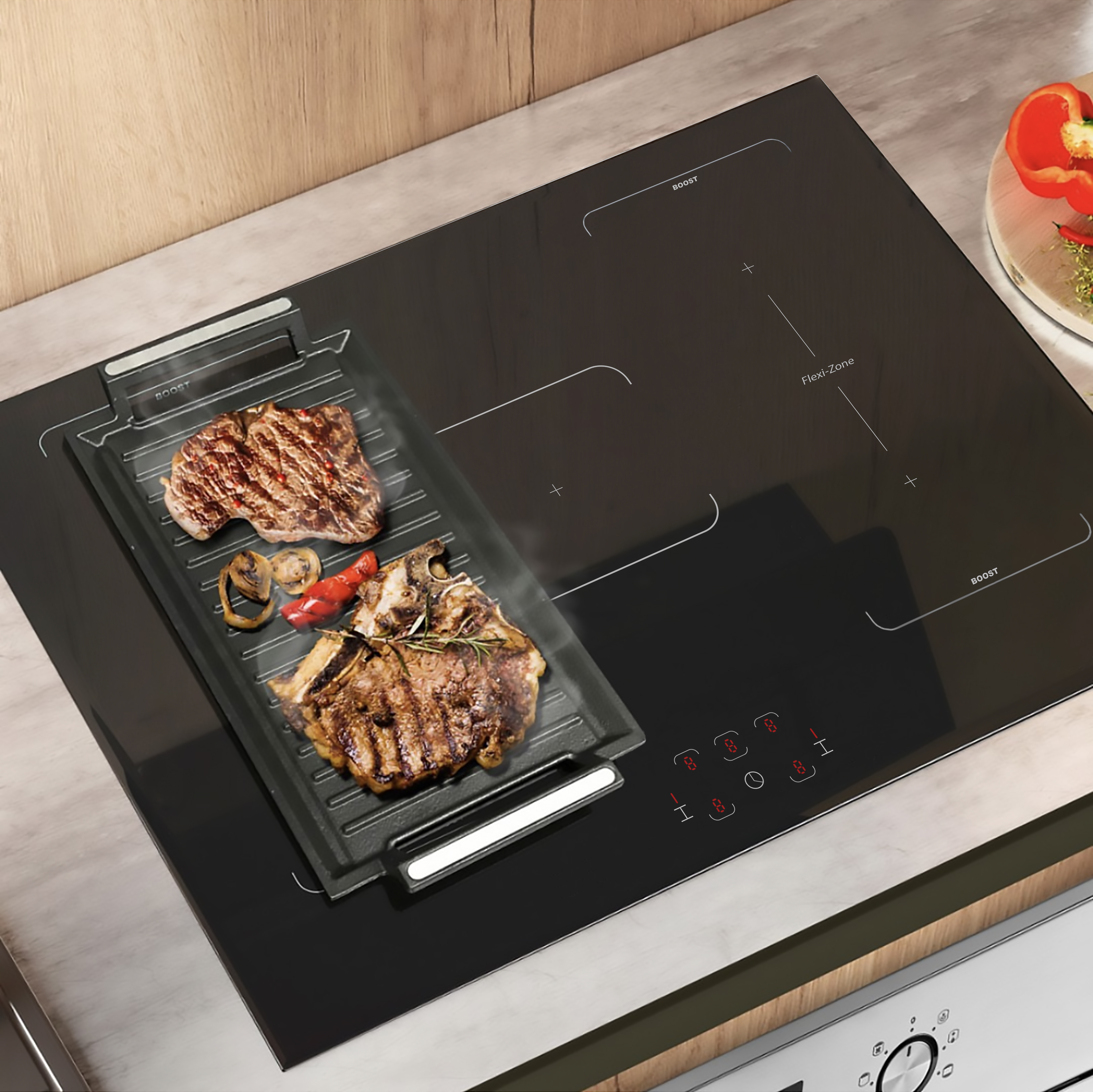 Ein schwarzes Induktionskochfeld mit gebratenen Steaks und Paprika auf einer Grillplatte.