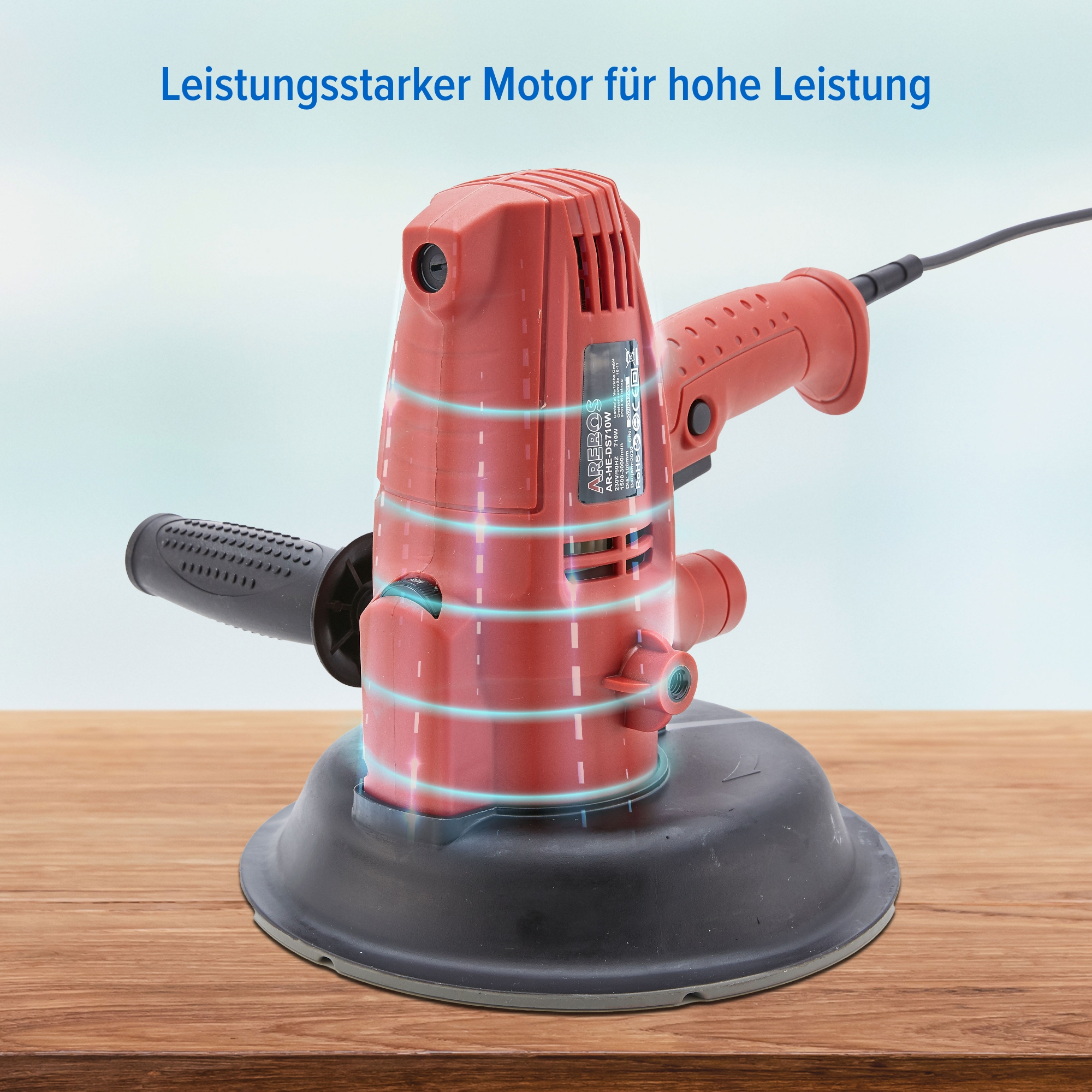Ein roter Schleifer mit schwarzem Sockel auf einer Holzoberfläche.