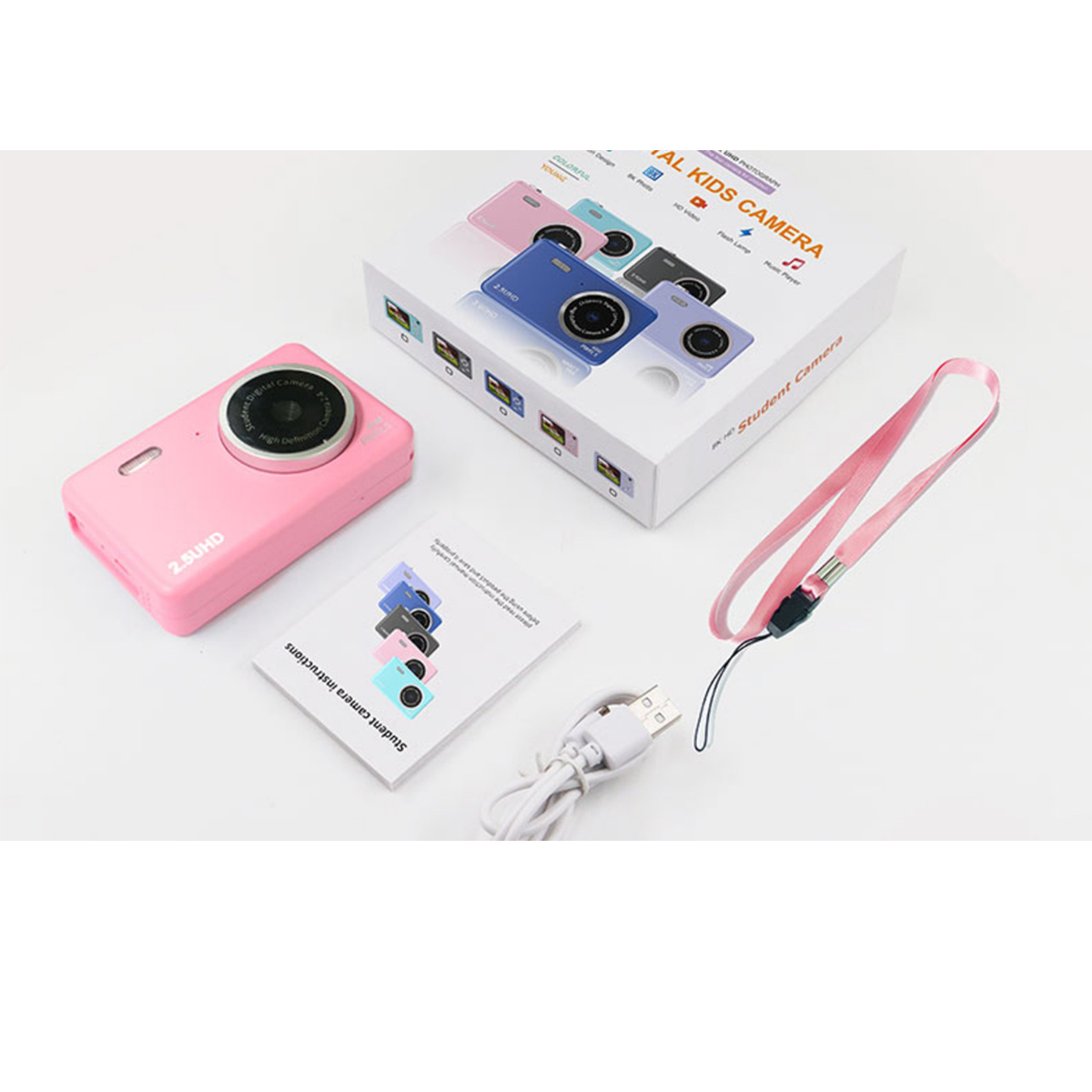 Cámara digital rosa para niños con accesorios y una caja. La cámara está junto a instrucciones y una correa.