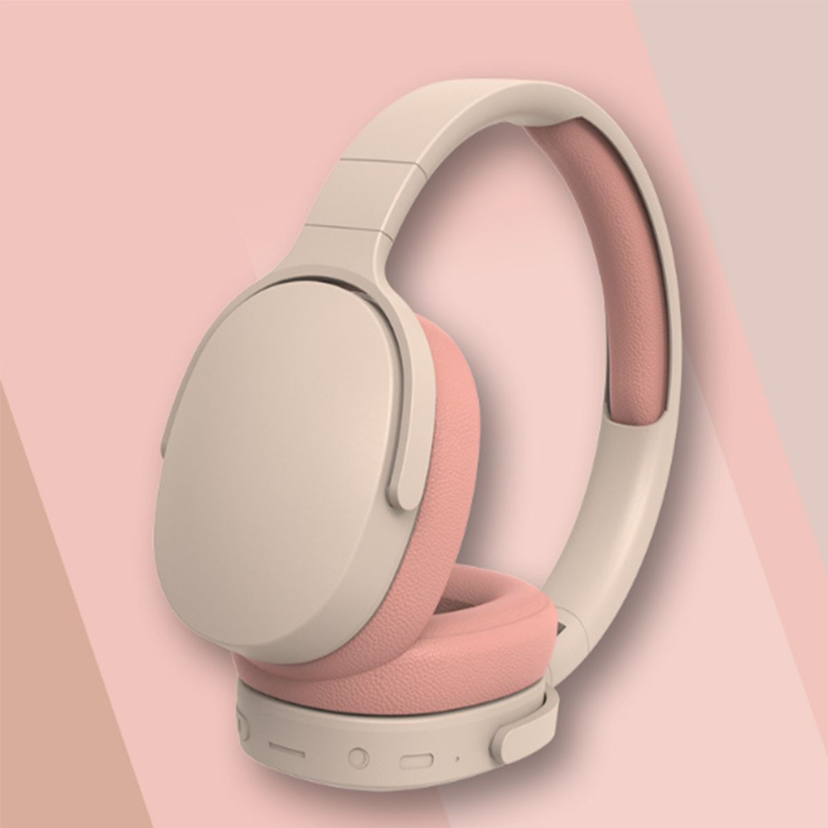 Rosa und beige Kopfhörer auf rosa gemustertem Hintergrund.
