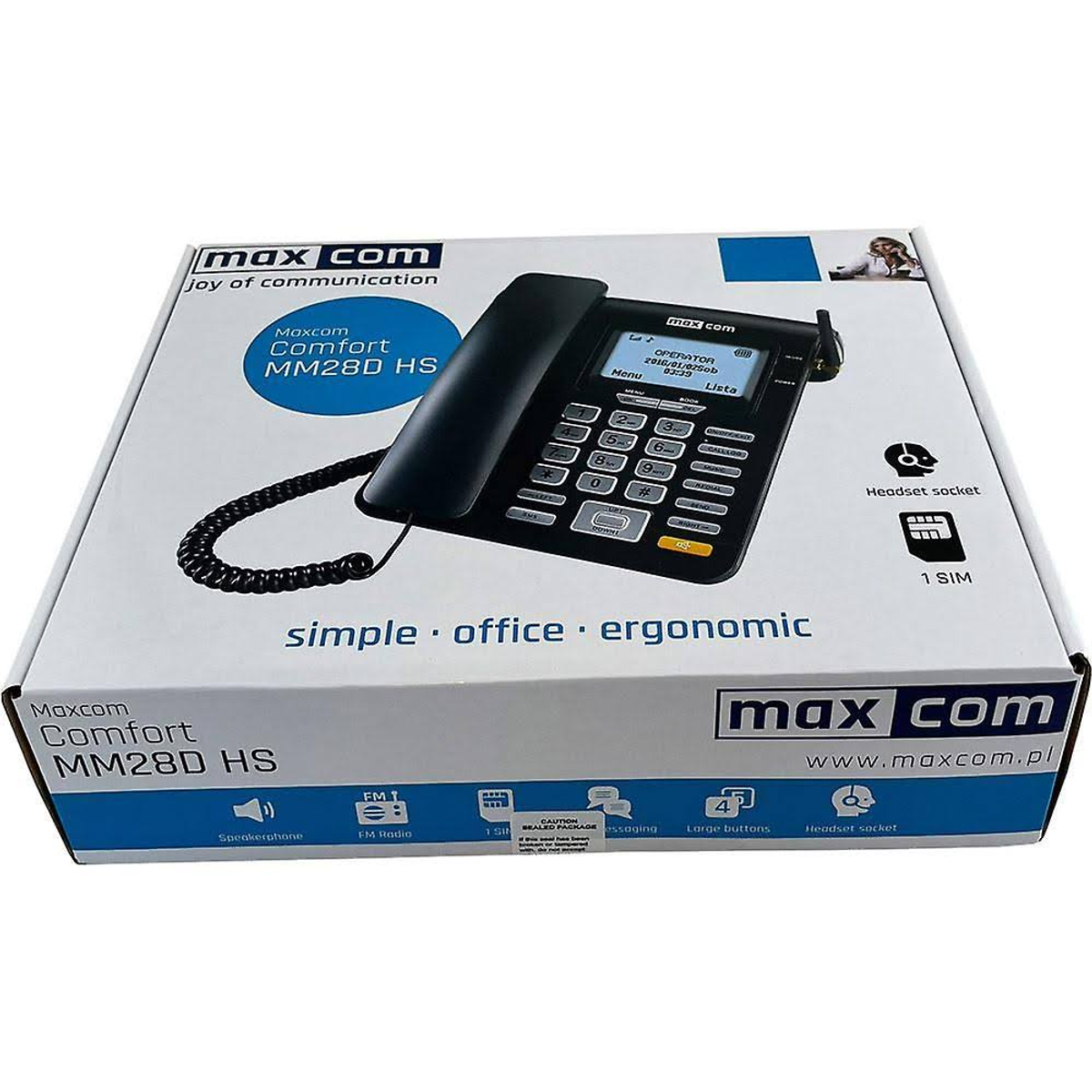 Teléfono Maxcom en una caja. Es negro con pantalla y botones. La caja tiene texto.