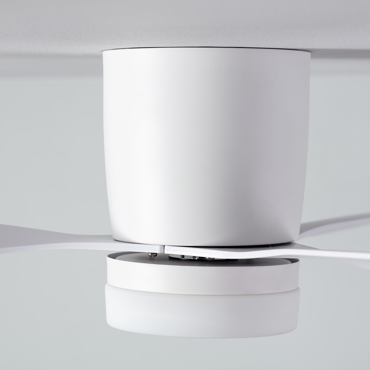 Un ventilatore da soffitto bianco con tre pale e una luce centrale.
