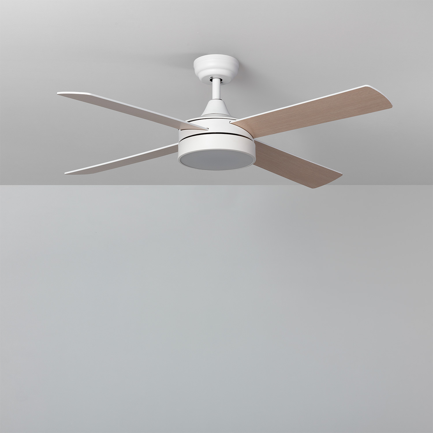 Ventilatore da soffitto bianco con cinque pale, finitura in tonalità legno, su soffitto bianco. Sfondo: muro grigio.