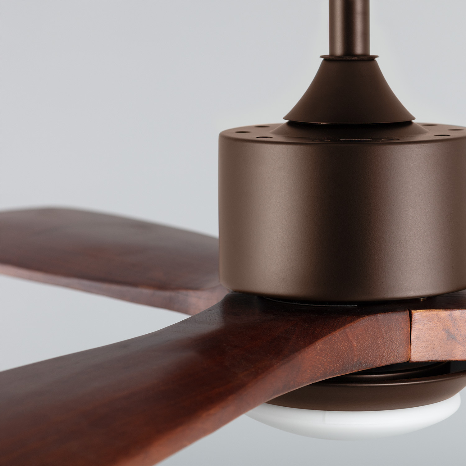 Ventilatore a soffitto, motore e pale marroni scuri. Primo piano dei componenti.