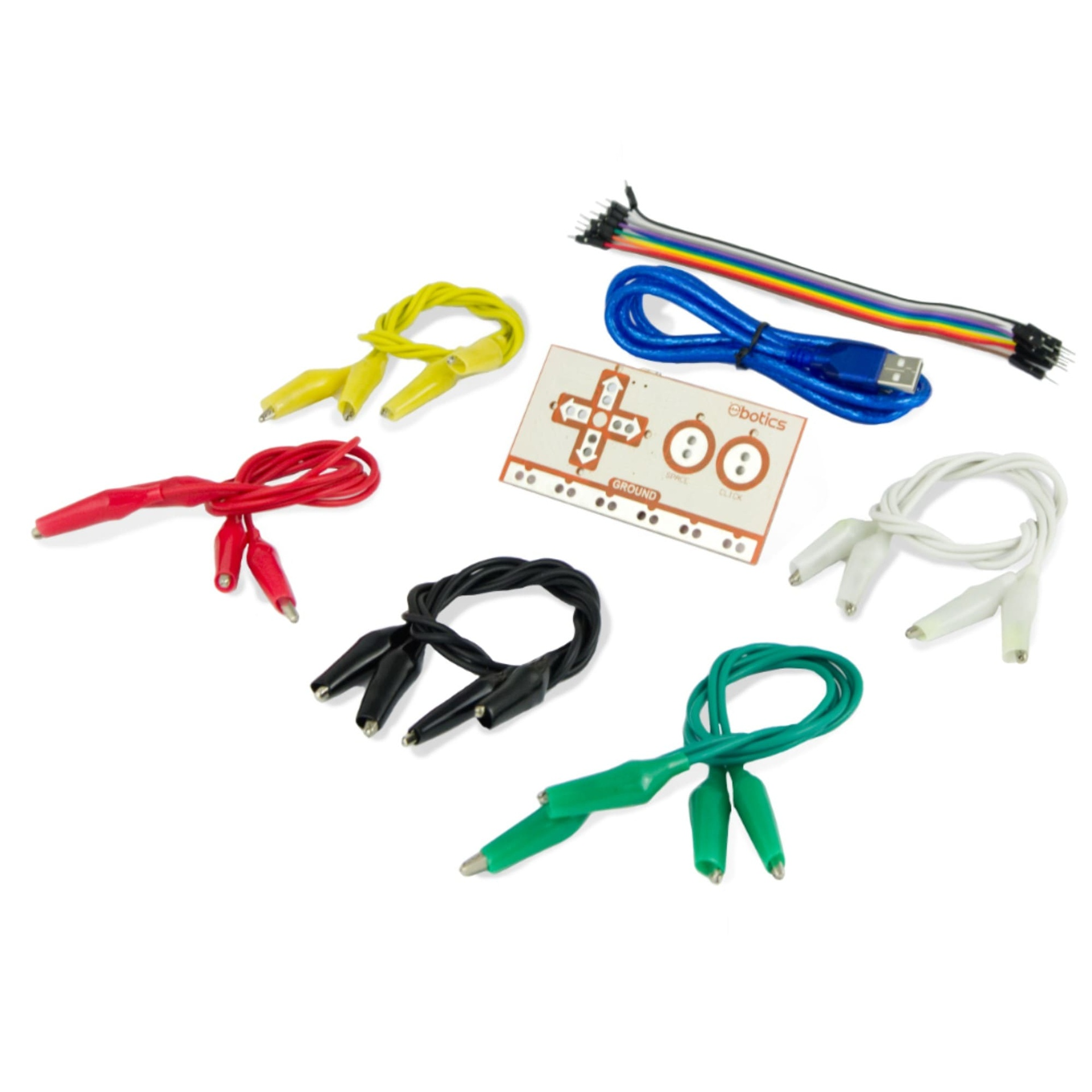Pinzas de cocodrilo, cables y una placa de circuito de colores variados, en una superficie blanca.