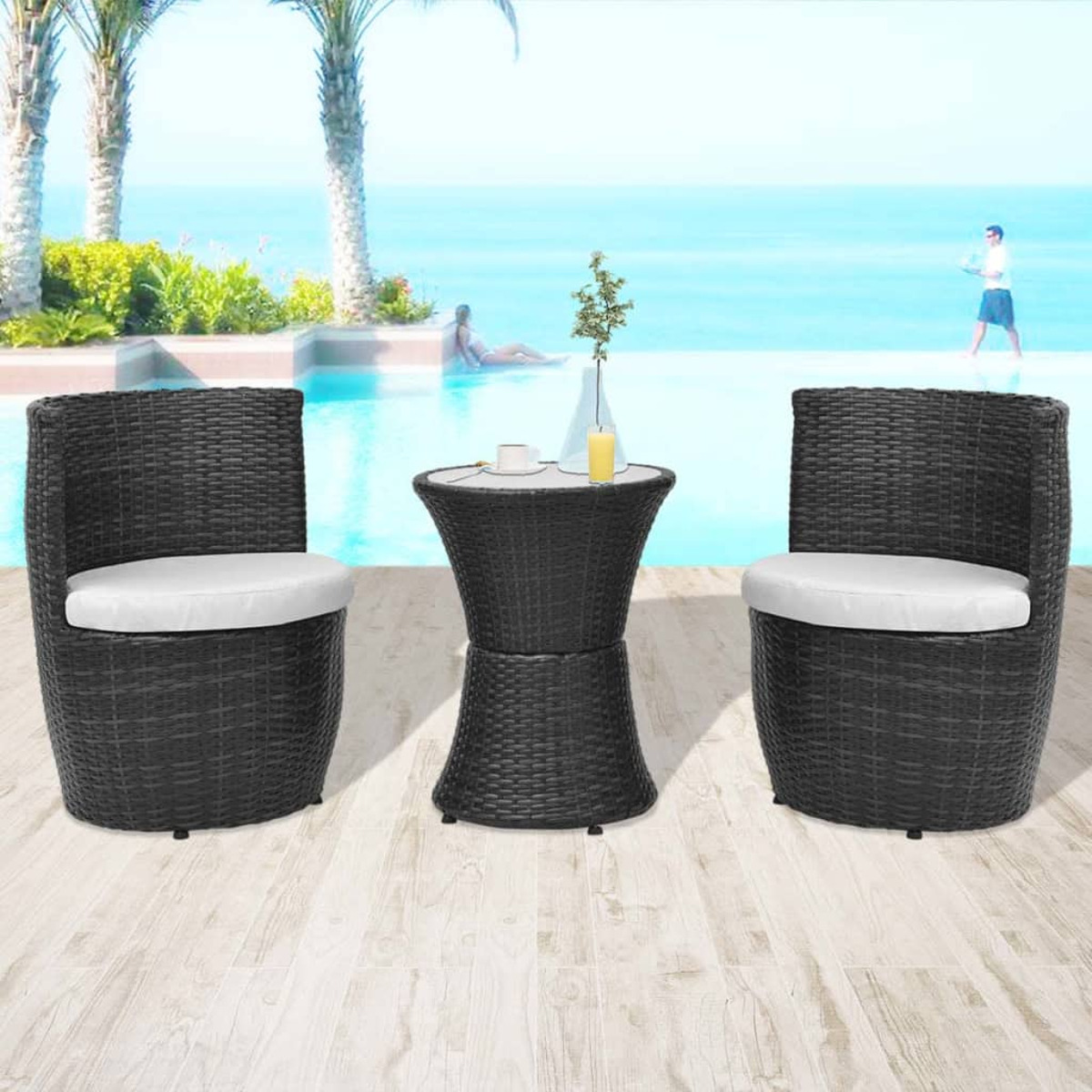 Gartenmöbel-Set mit zwei Stühlen und einem kleinen Tisch. Schwarzes Korbgeflecht, weiße Kissen.