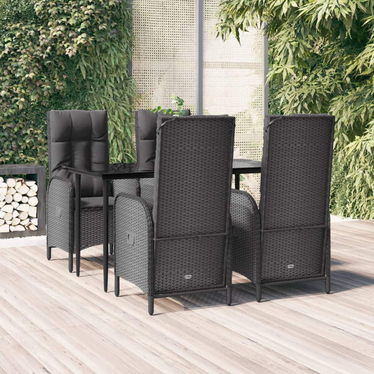 Ein schwarzes, gewebtes Ess-Set für den Außenbereich mit Tisch und vier Stühlen. Das Set steht auf einem Holzdeck.