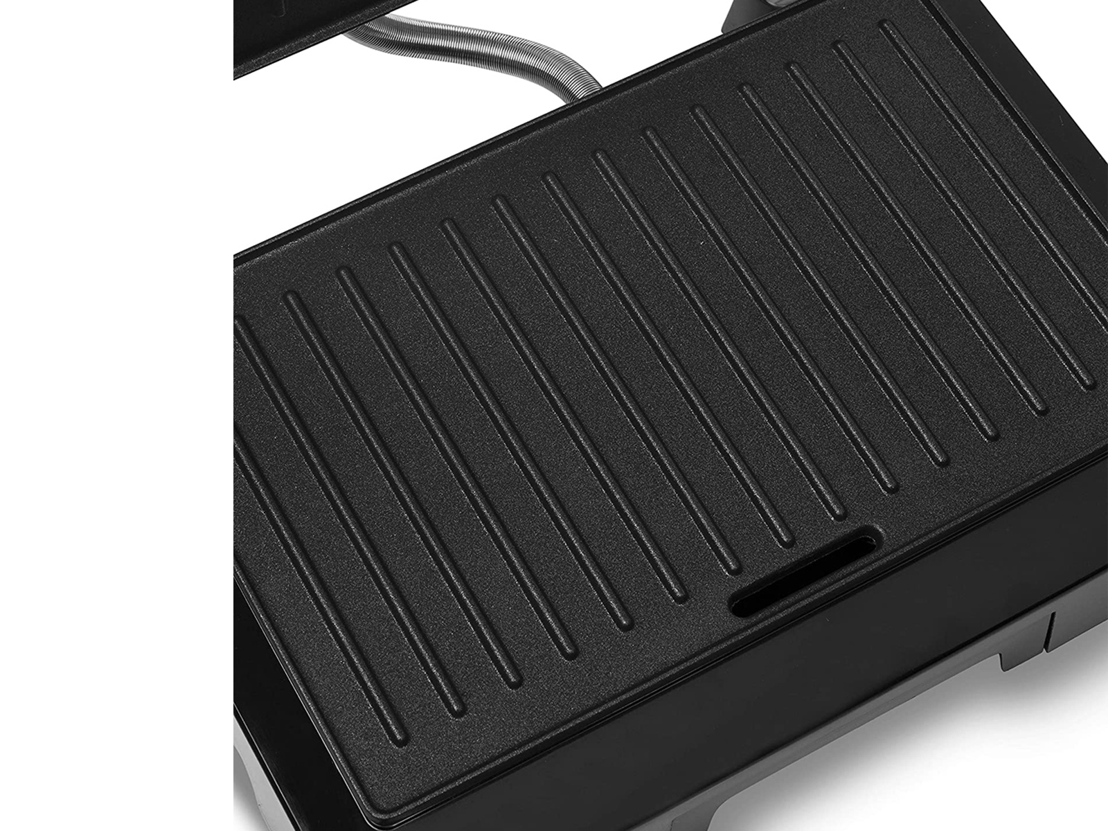Nahaufnahme der Grillfläche einer Panini-Presse. Sie hat schwarze, vertikale Rillen.
