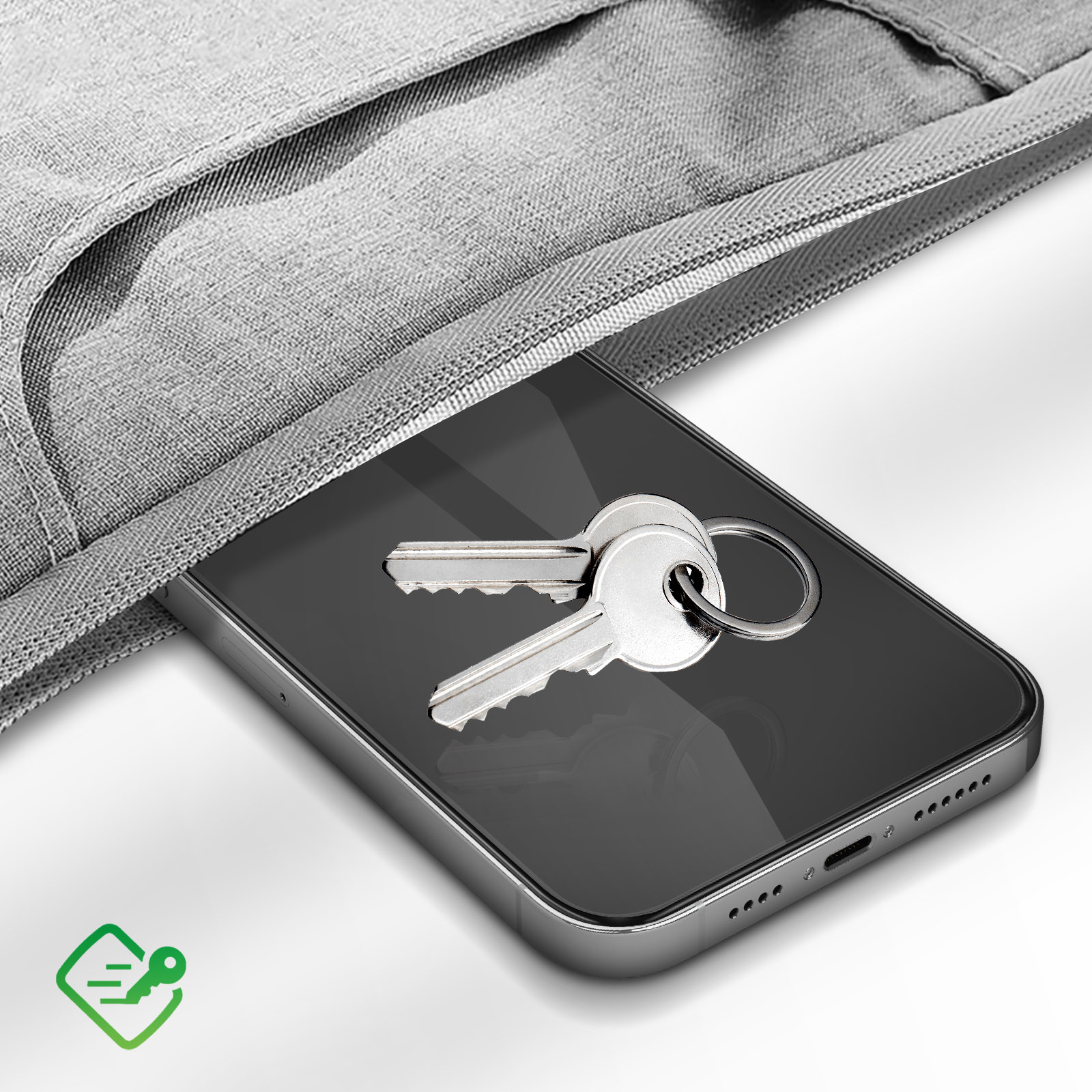 Telefono con chiavi all'interno di una borsa grigia, con un'icona a forma di chiave verde nell'angolo in basso a sinistra.