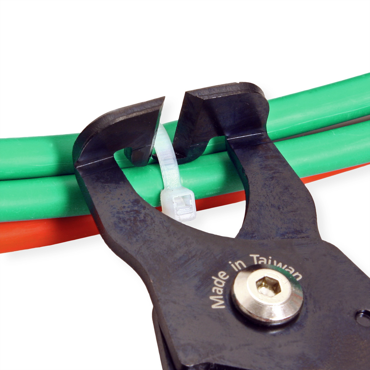 Pliers cutting a white zip tie, with green and orange cables in the background.