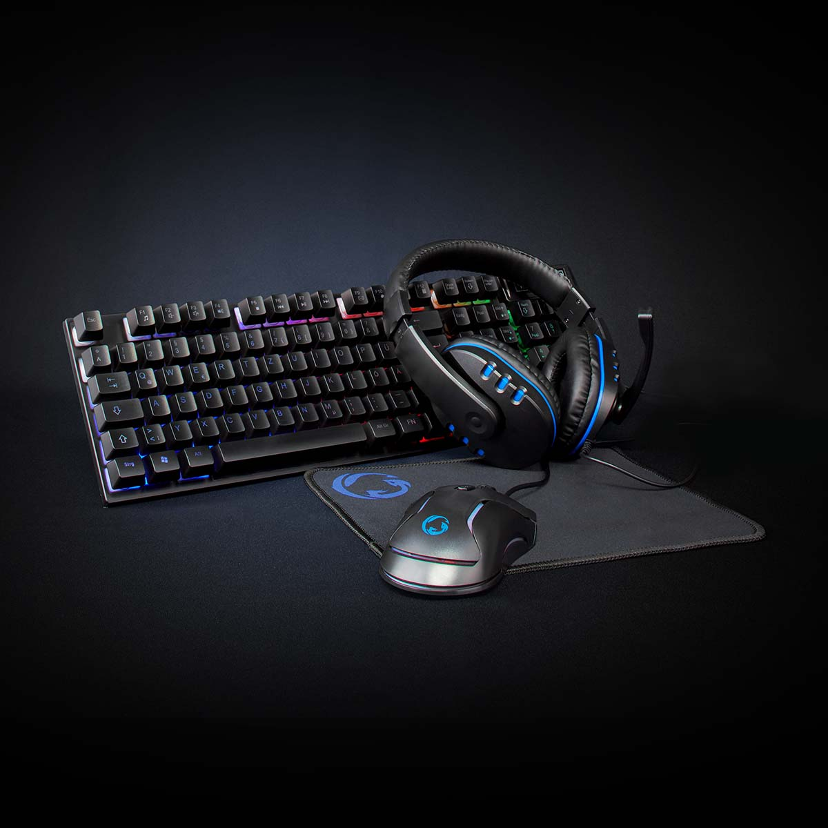 A gaming setup with a keyboard, mouse, mousepad, and headphones.