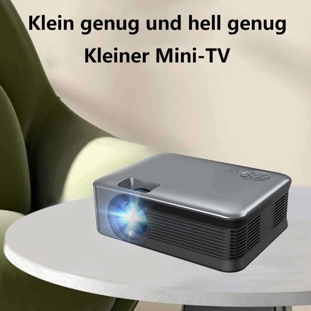 Un proyector gris sobre una mesa blanca. Texto: "Mini-TV pequeño" y "Lo suficientemente pequeño y brillante".