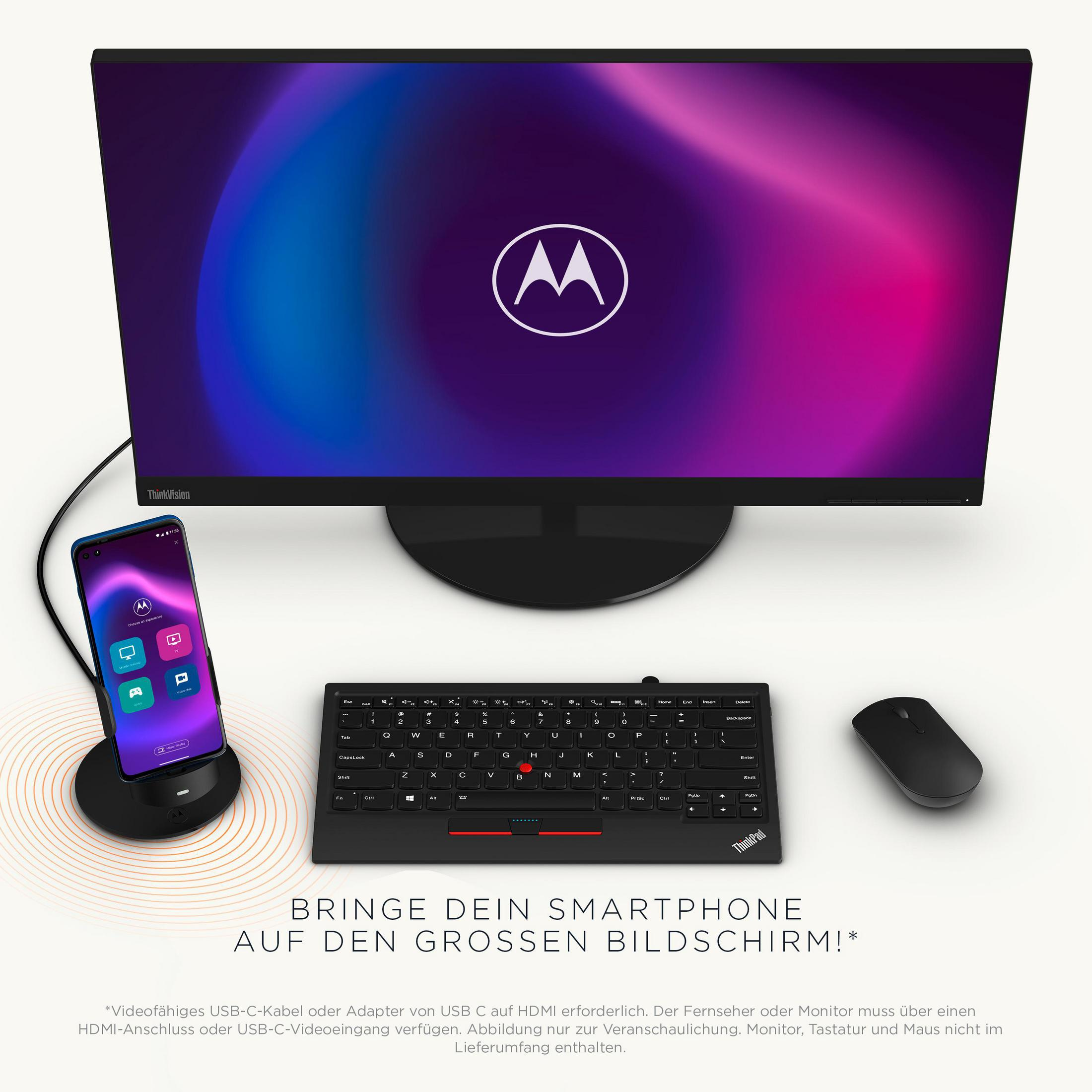 Ein Monitor, eine Tastatur, eine Maus und ein Telefon stehen auf einem Schreibtisch. Das Telefon ist angedockt.