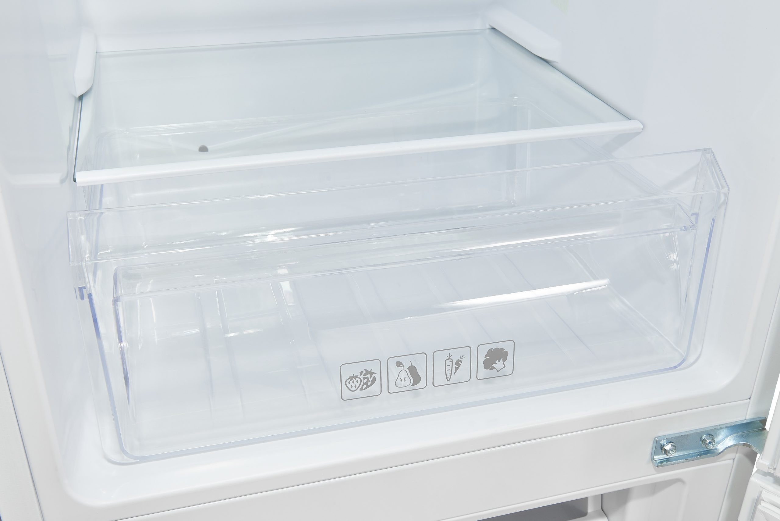 Ein Kühlschrankinnenraum mit transparenten Plastikschubladen für Gemüse und Obst.