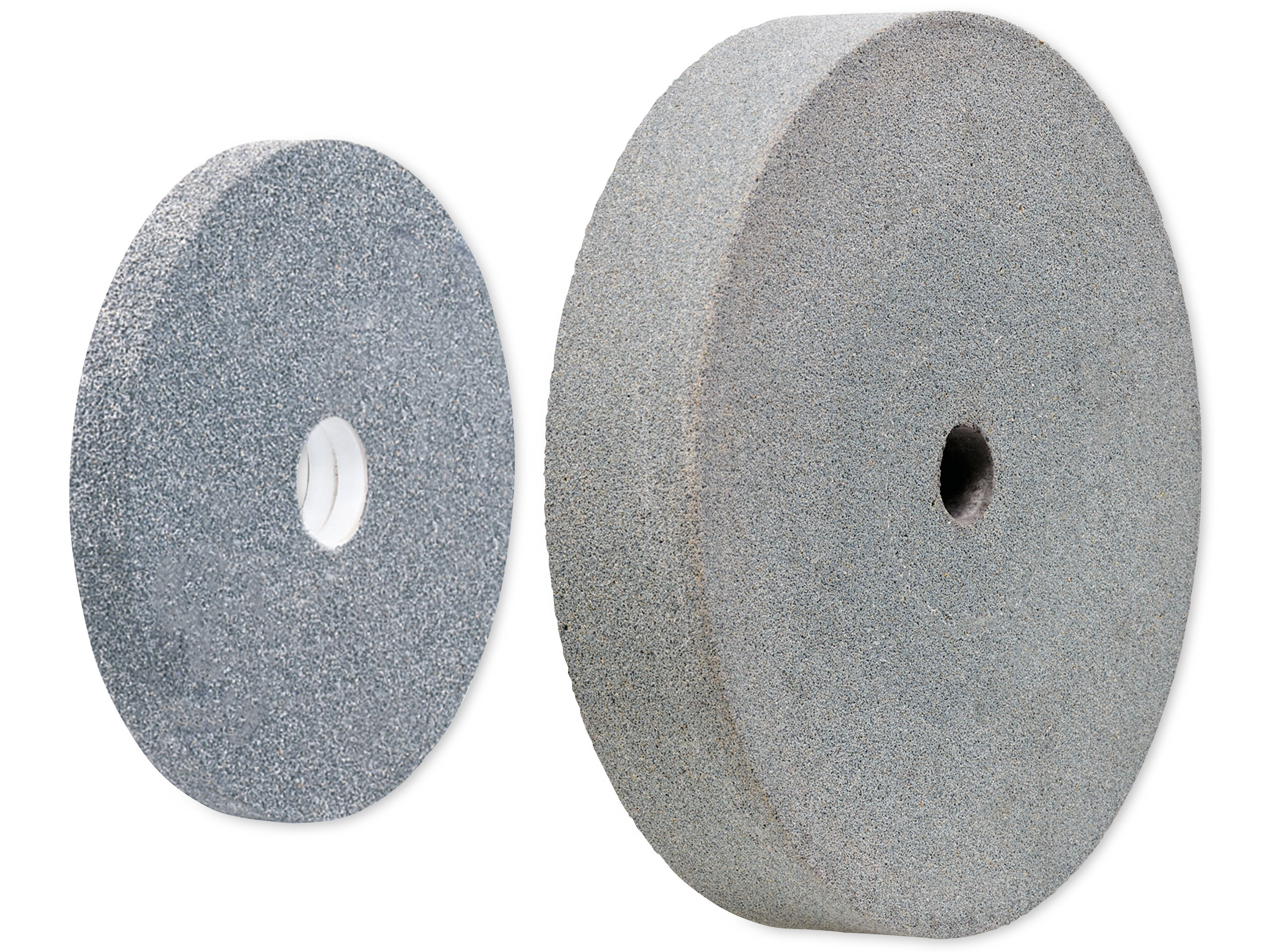 Dwa szare ściernice z otworami. Jeden stoi pionowo, a drugi leży na boku.