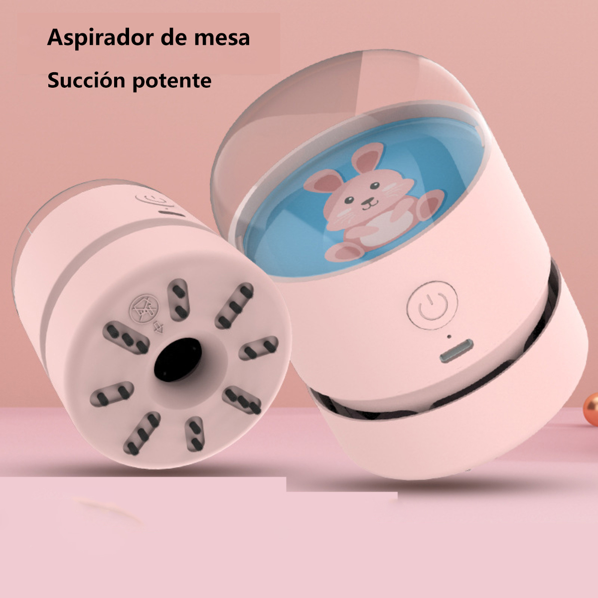 Mini aspiradora rosa con una ilustración de conejo. Tiene un botón y un puerto de carga.