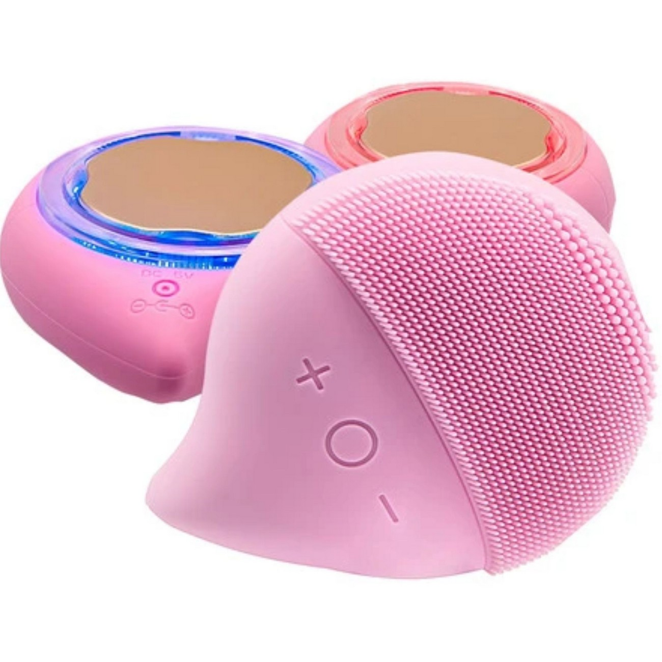 Tres dispositivos de limpieza facial rosas. Uno con cepillo, otros dos con superficie de espejo.