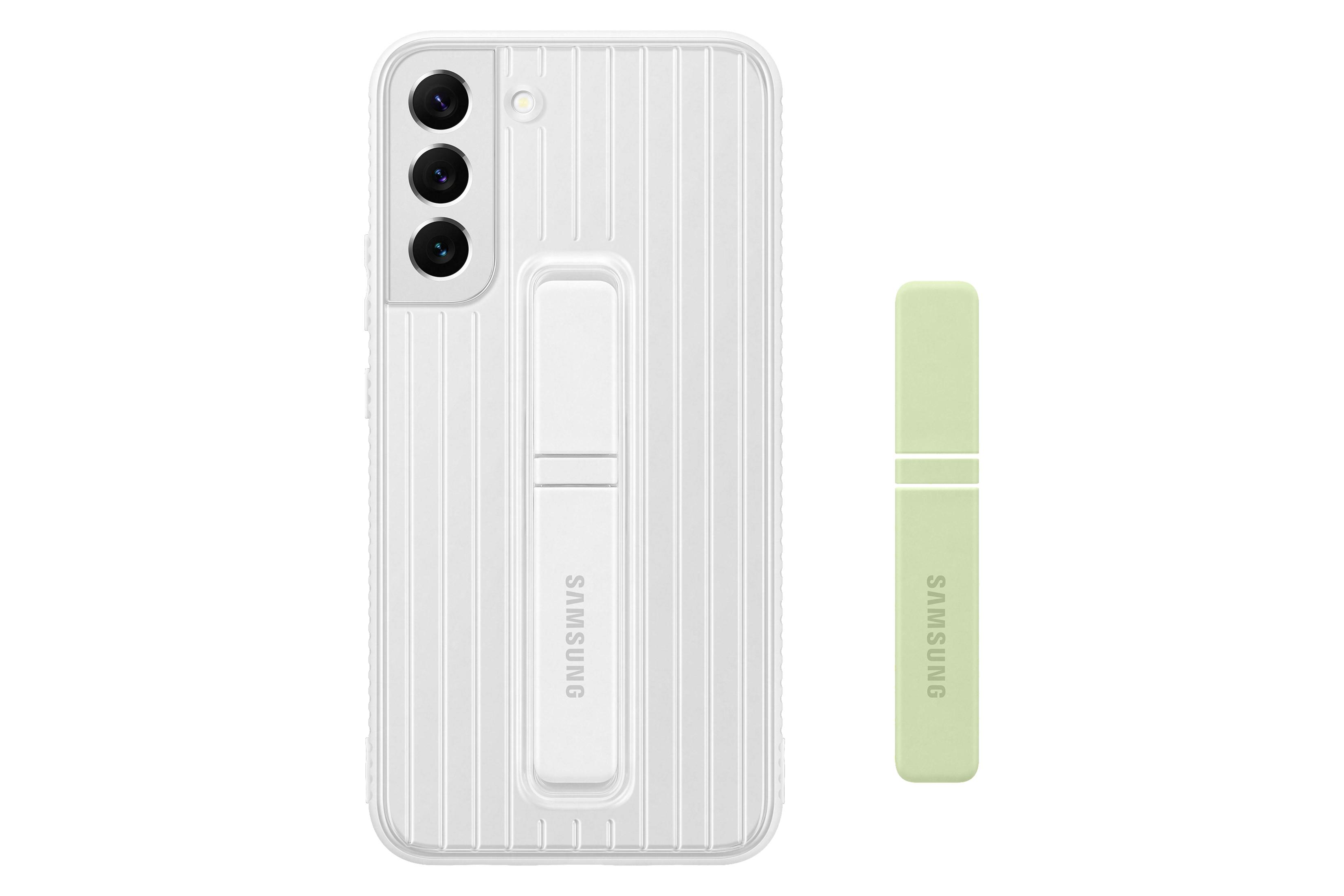 Téléphone blanc avec étui et support. L'étui a un support et un accessoire vert à côté.