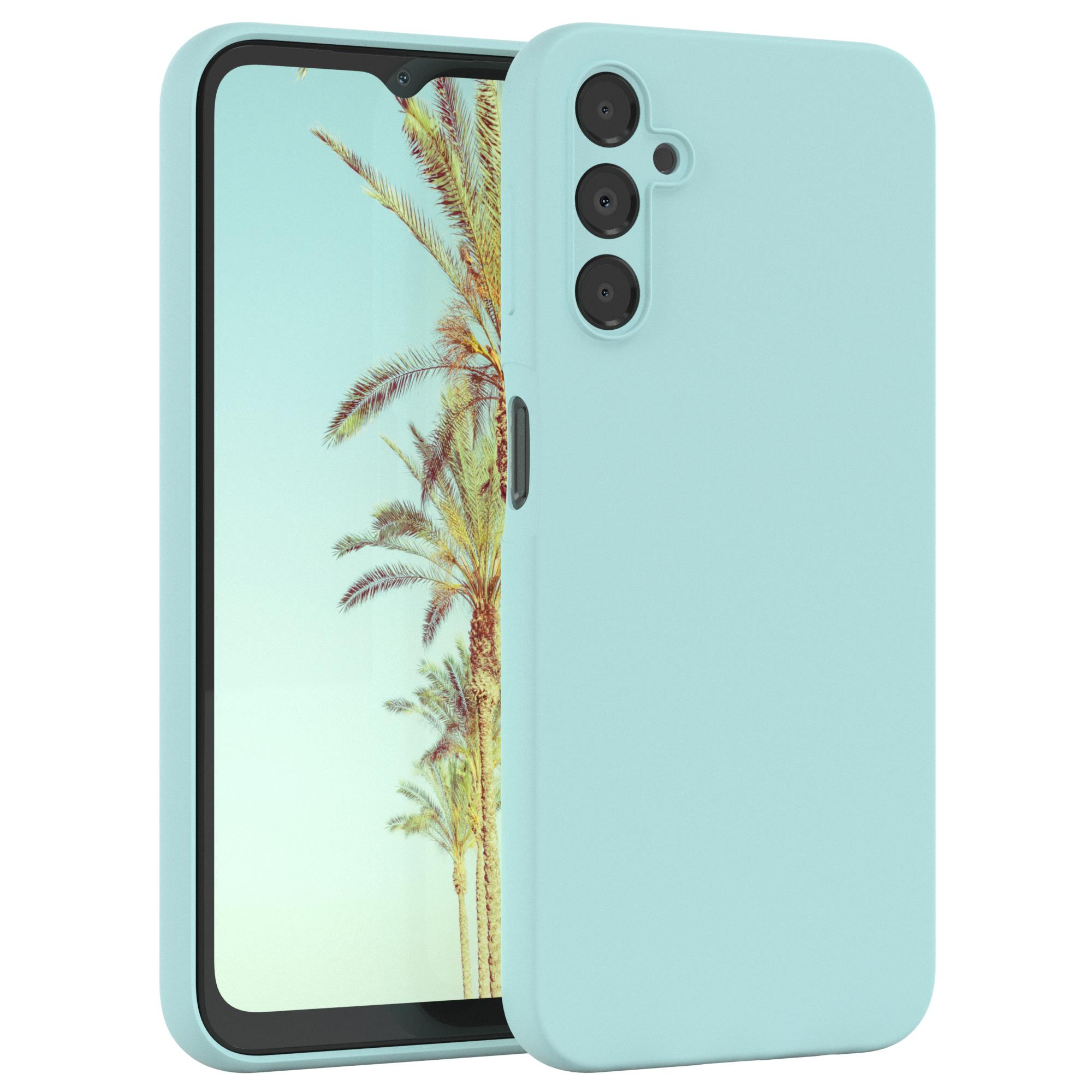 Eine hellblaue Handyhülle. Die Hülle bedeckt ein Telefon. Der Hintergrund zeigt eine Strandszene.