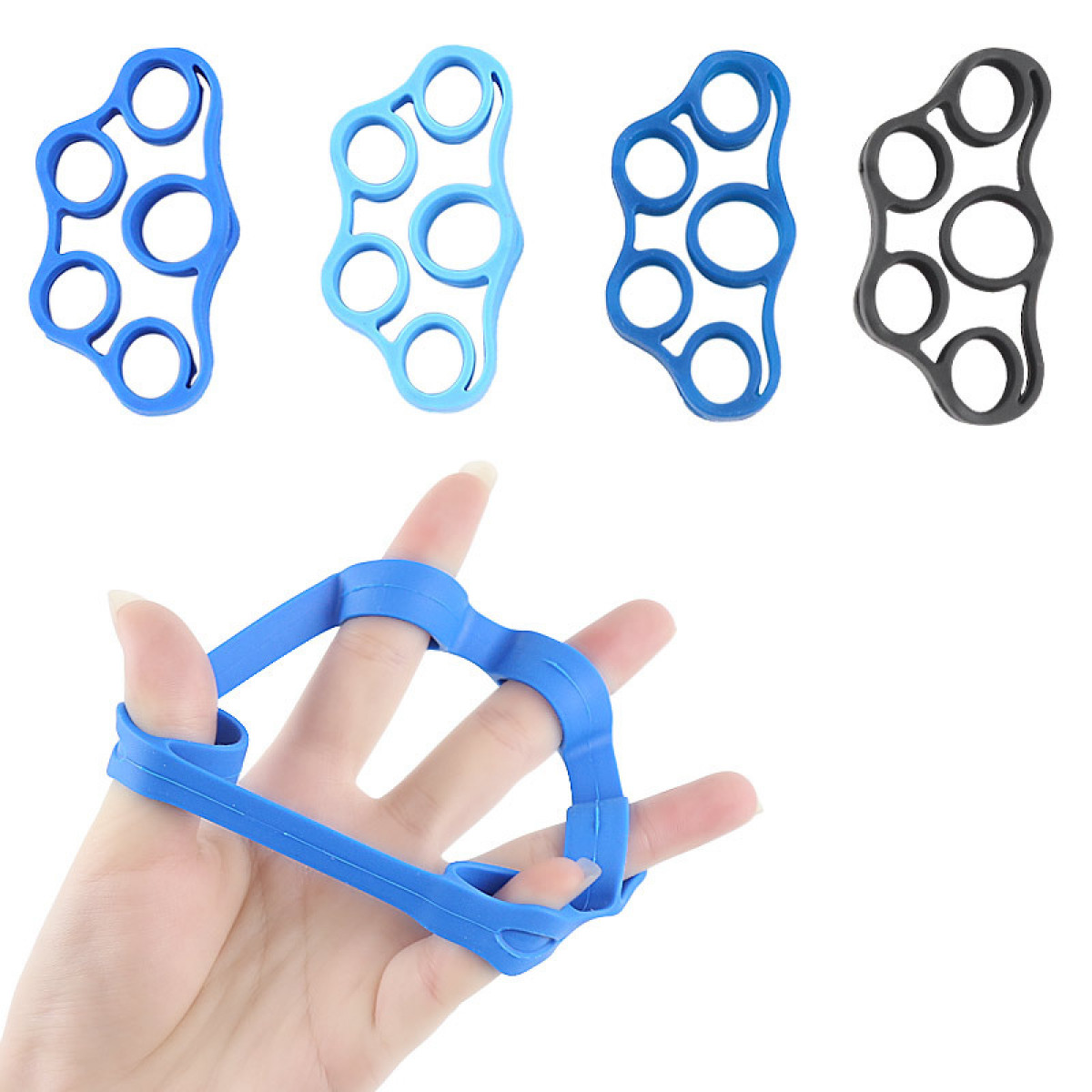 Eine Hand, die einen blauen Finger-Trainer und andere farbige hält.