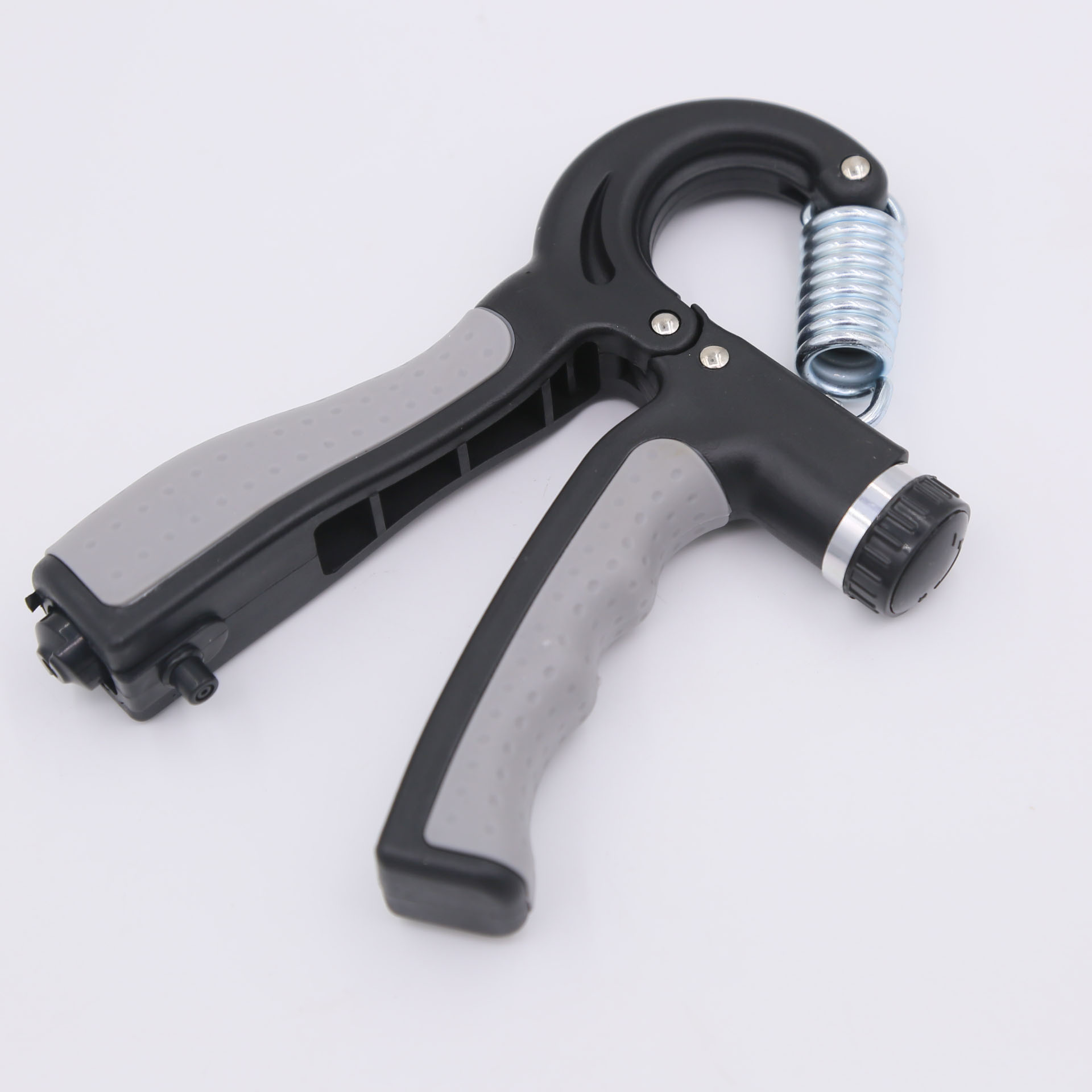 Przyrząd do ćwiczeń chwytu dłoni, czarno-szary ze srebrną sprężyną.